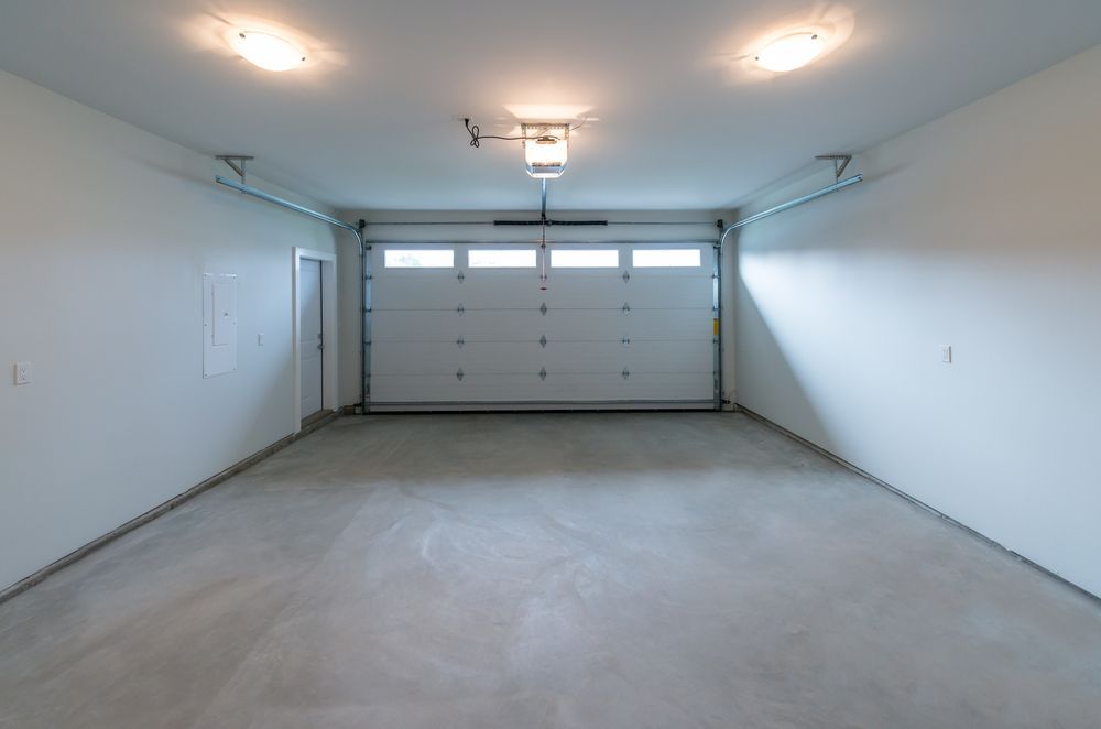 Empty White Garage and Concrete Floor — Coastal Auto Garage Doors & Gates In Caboolture, QLD