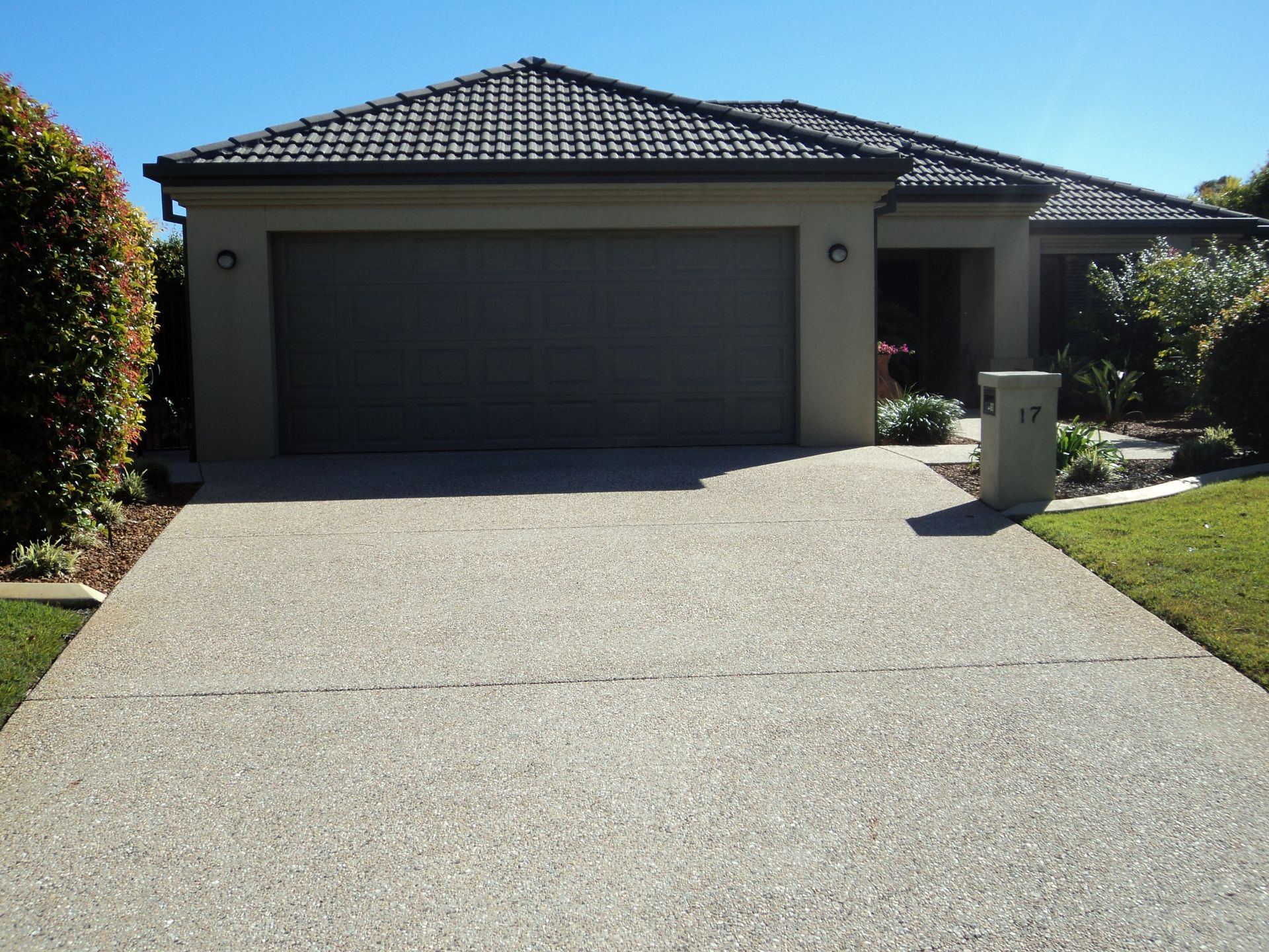 House With a Garage Door and Driveway — Coastal Auto Garage Doors & Gates In Morayfield, QLD
