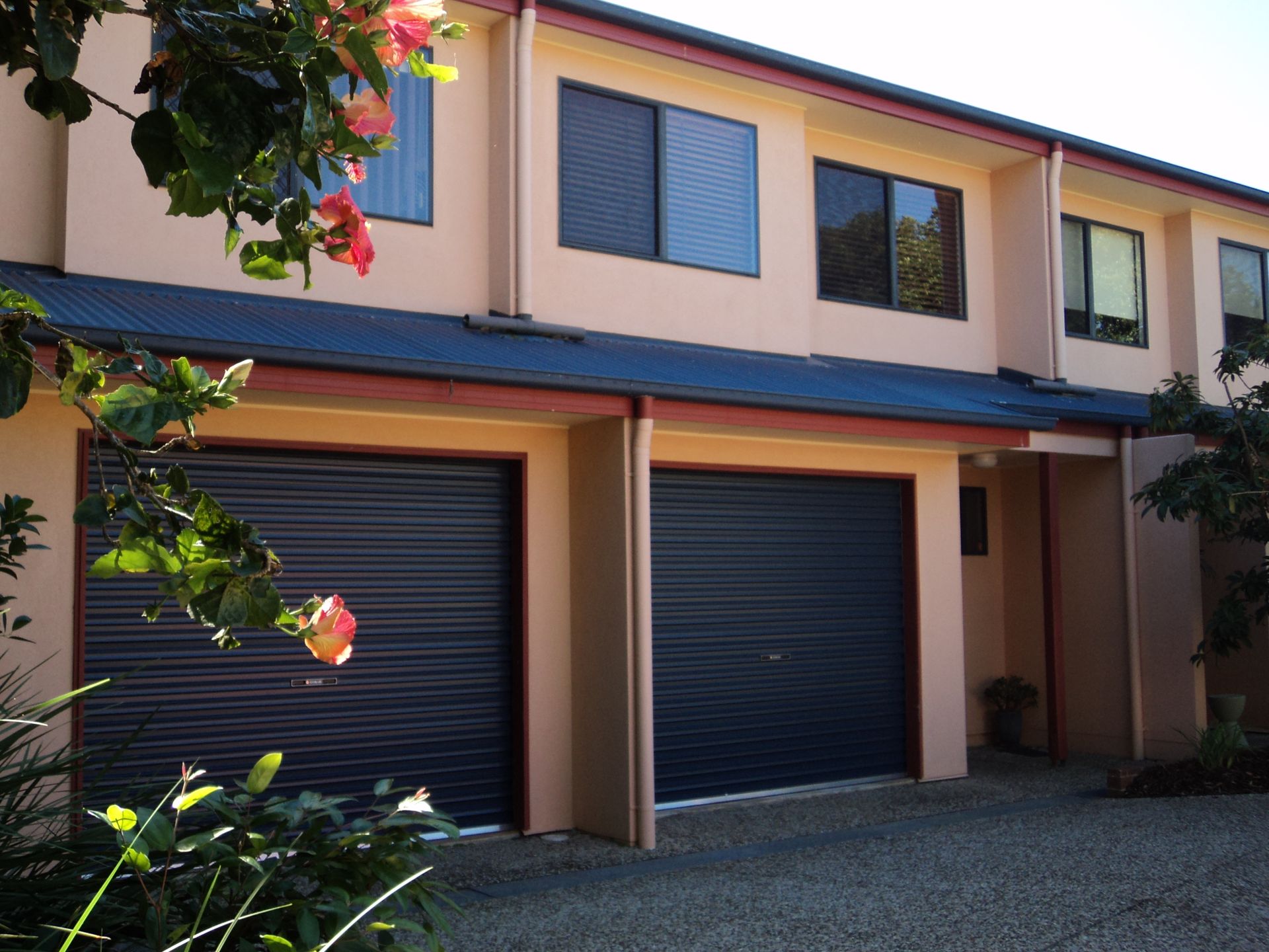Two-story Townhouse With Dark Garage Doors — Coastal Auto Doors & Gates In Nambour, QLD