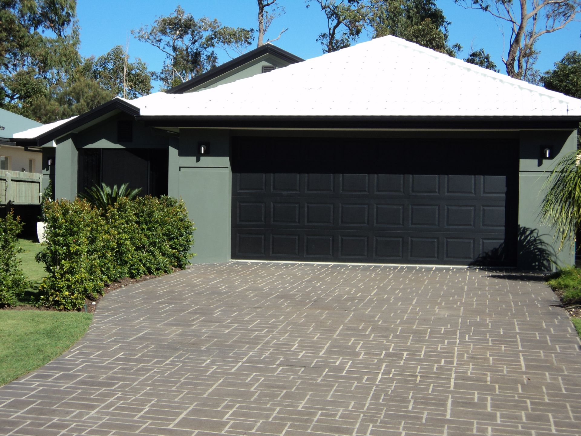 House With a Black Garage Door and Driveway — Coastal Auto Doors & Gates In Nambour, QLD
