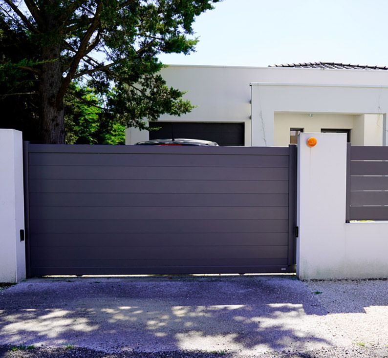 A Grey Panelled Sliding Gate with White Rendered Walls — Coastal Auto Garage Doors & Gates In Caboolture, QLD