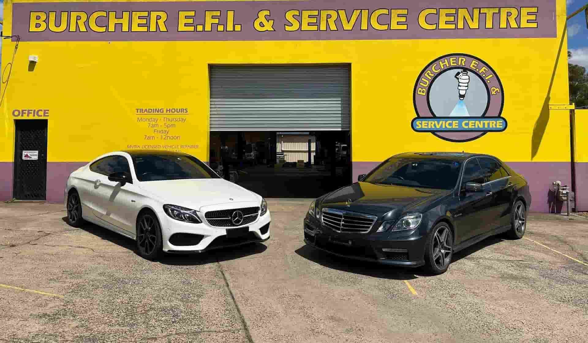 Two Mercedes Cars Parked in Front of a Yellow Auto Repair Shop — Burcher EFI & Service Centre in Orange, NSW