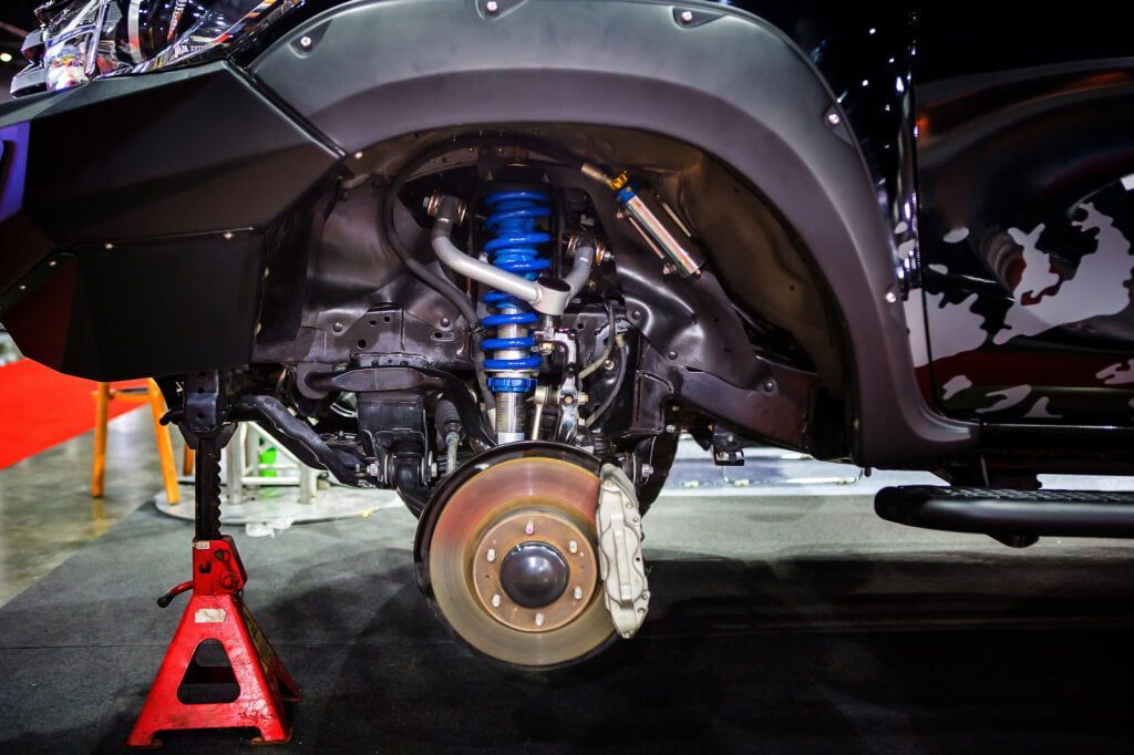 Black Truck's Front Wheel Removed, Revealing Suspension and Brake Rotor — Burcher EFI & Service Centre in Orange, NSW