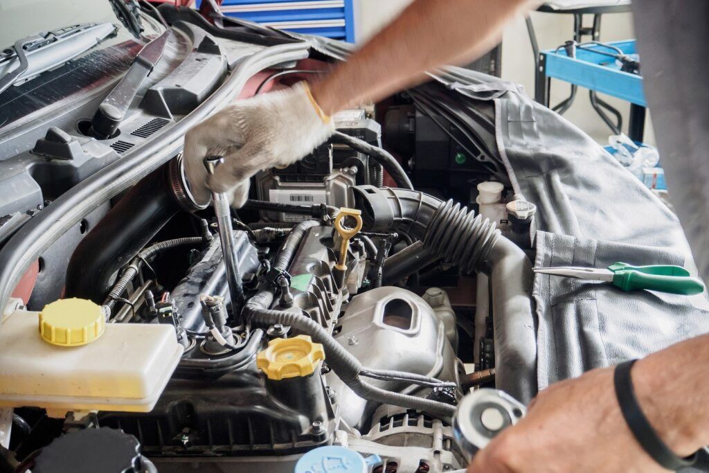 Mechanic Working on a Car Engine, Wearing Gloves and Using Tools — Burcher EFI & Service Centre in Orange, NSW