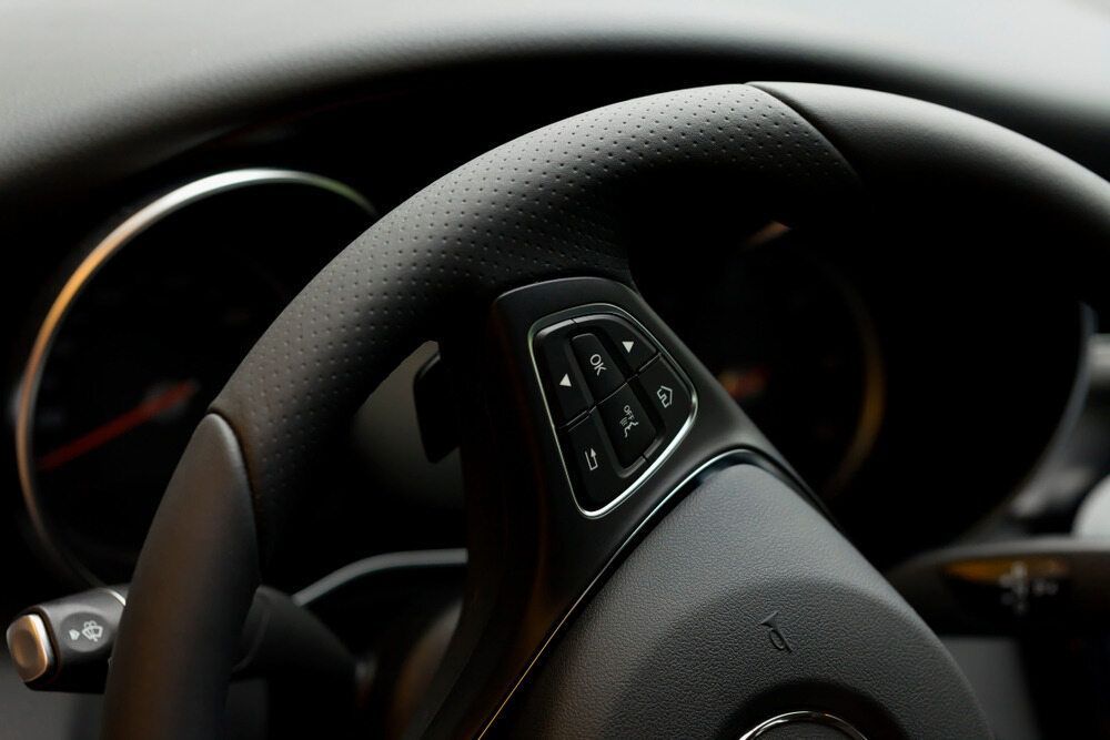 Black Leather Car Steering Wheel With Control Buttons — Burcher EFI & Service Centre in Orange, NSW
