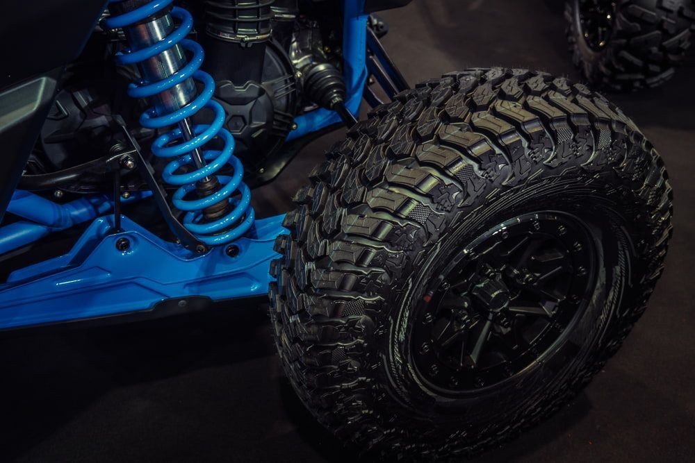 Blue Off-road Vehicle Wheel With a Black Tire. a Blue Spring is Visible — Burcher EFI & Service Centre in Orange, NSW