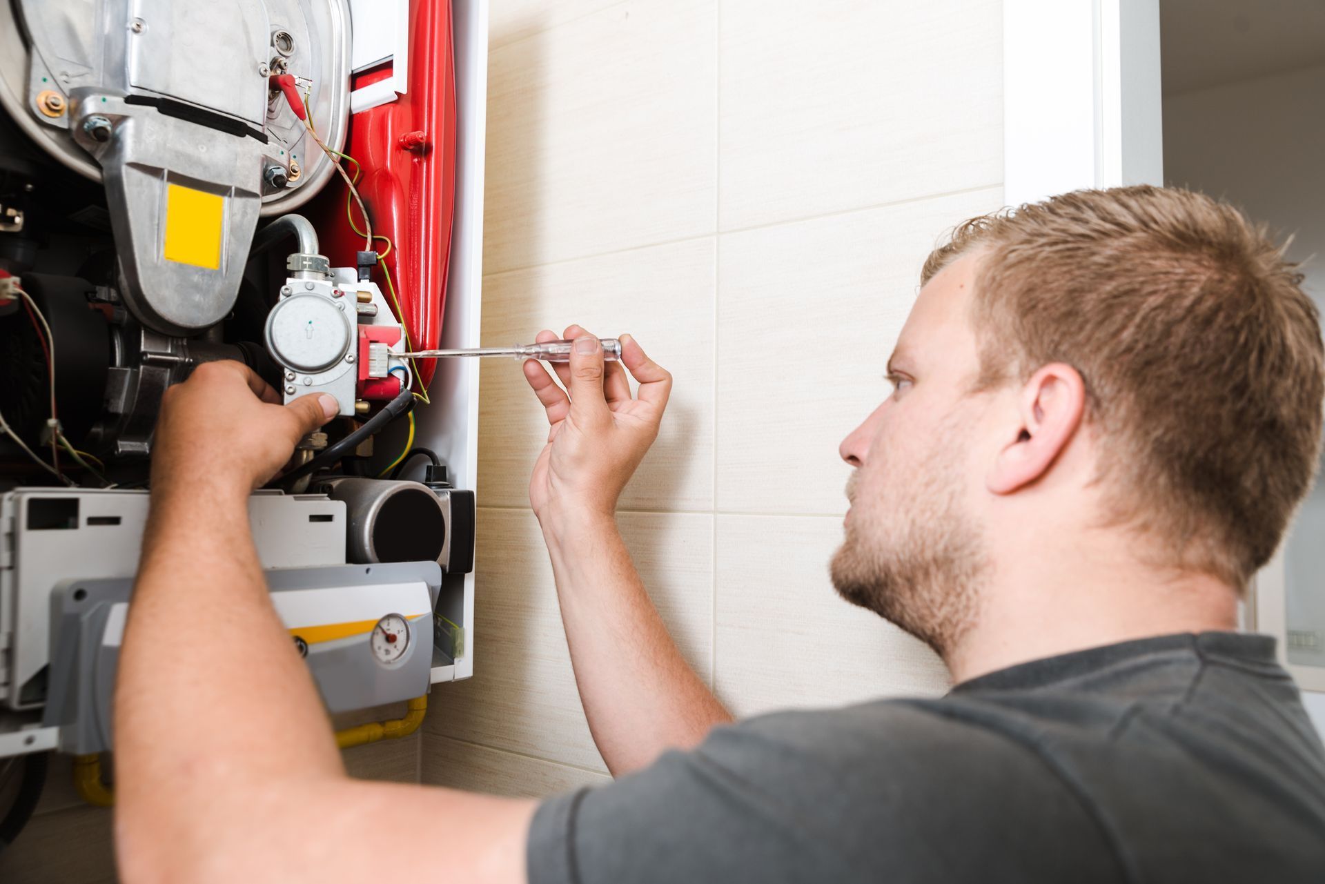 Furnace Repair: Skilled Technician Fixing a Gas Furnace.