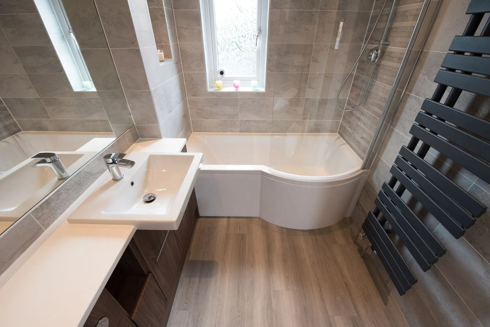 Modern Bathroom with Bathtub, Sink, and Towel Radiator in Gray and Wood Tones in Twin Falls, ID