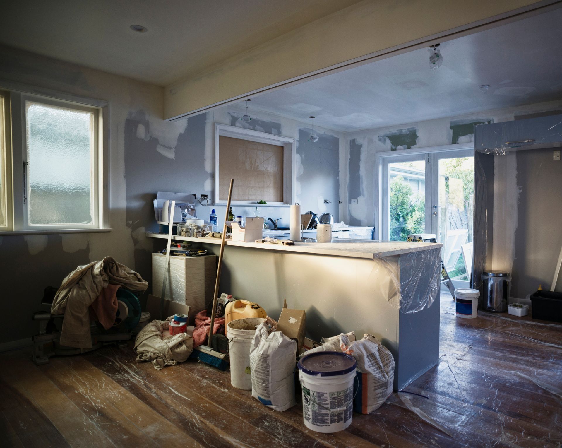 A Kitchen Under Construction with Buckets of Paint on The Floor in Twin Falls, ID