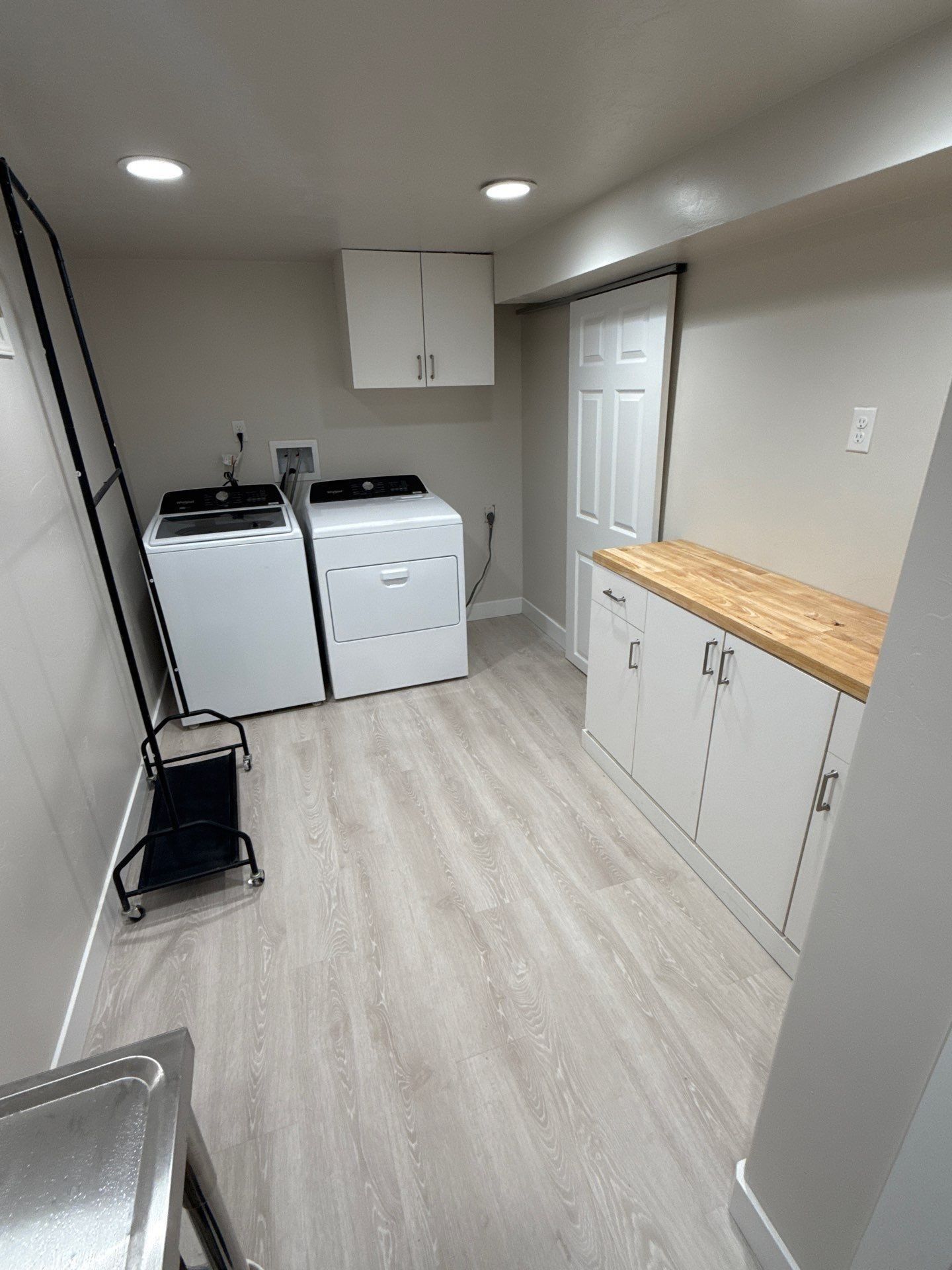 Laundry Room with Washer and Dryer, White Cabinets, and A Wooden Countertop in Twin Falls, ID