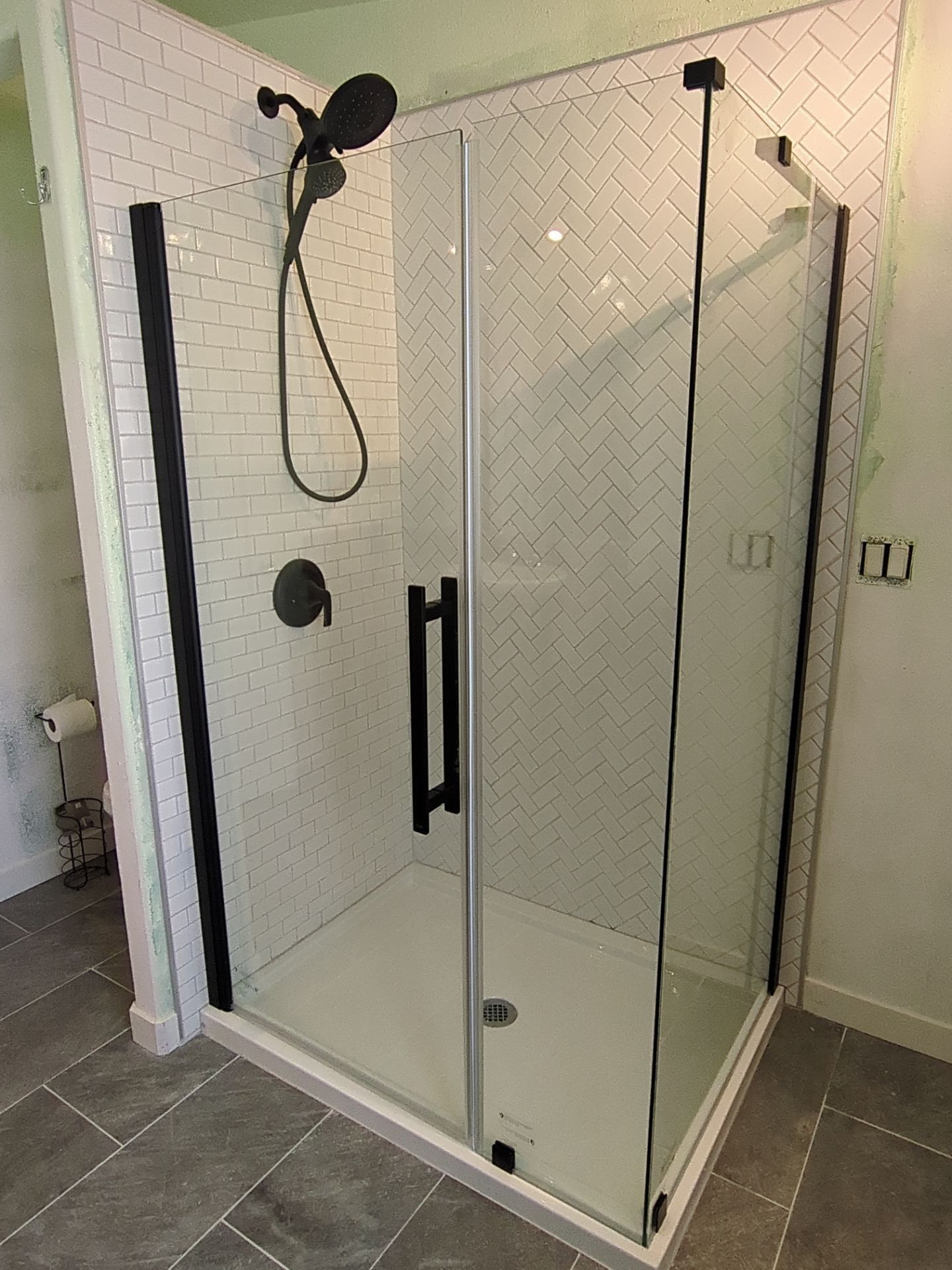 Glass Shower Stall with Black Fixtures and Tiled Bathroom Floor in Twin Falls, ID