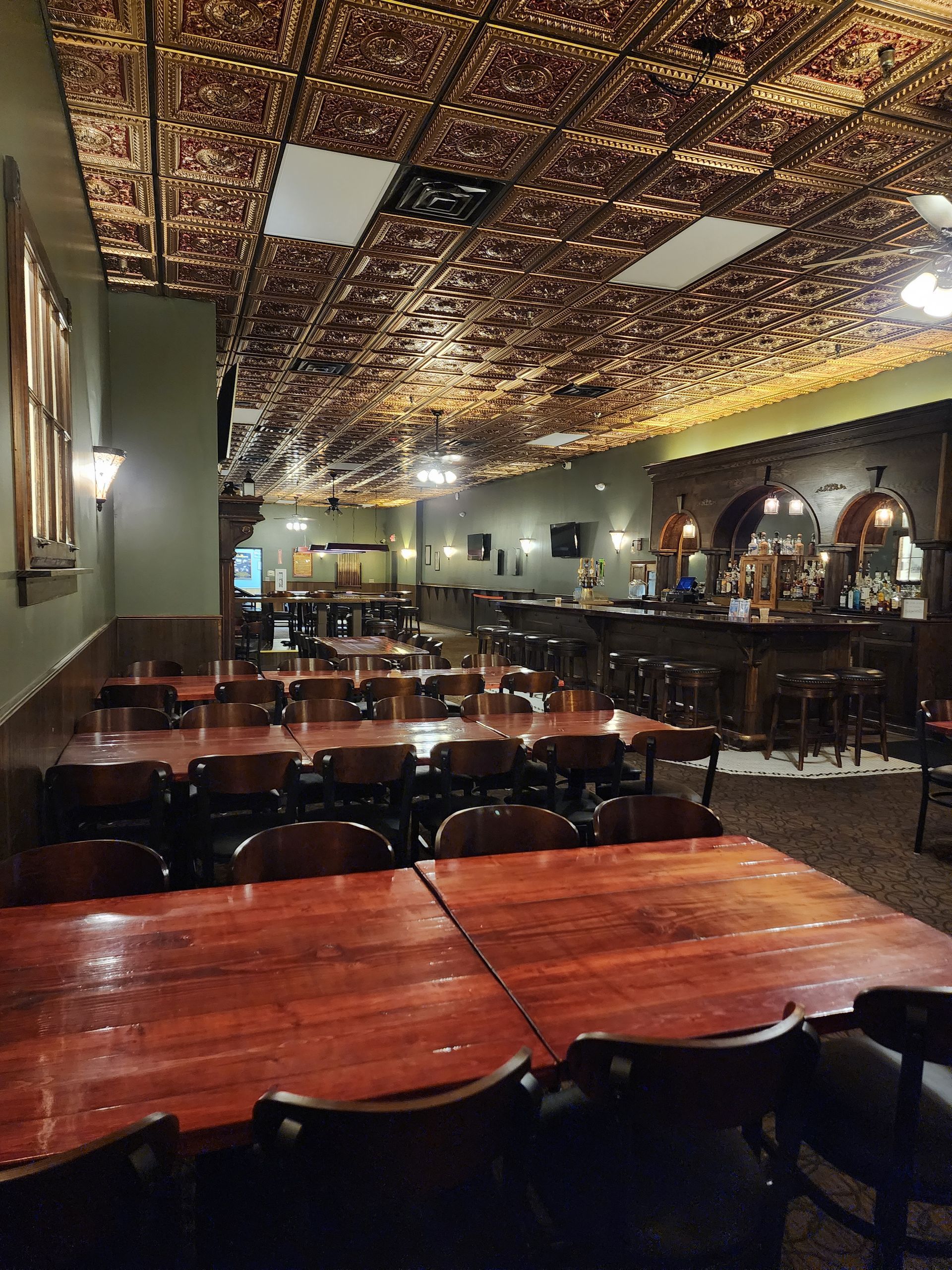 A restaurant with tables and chairs and a bar