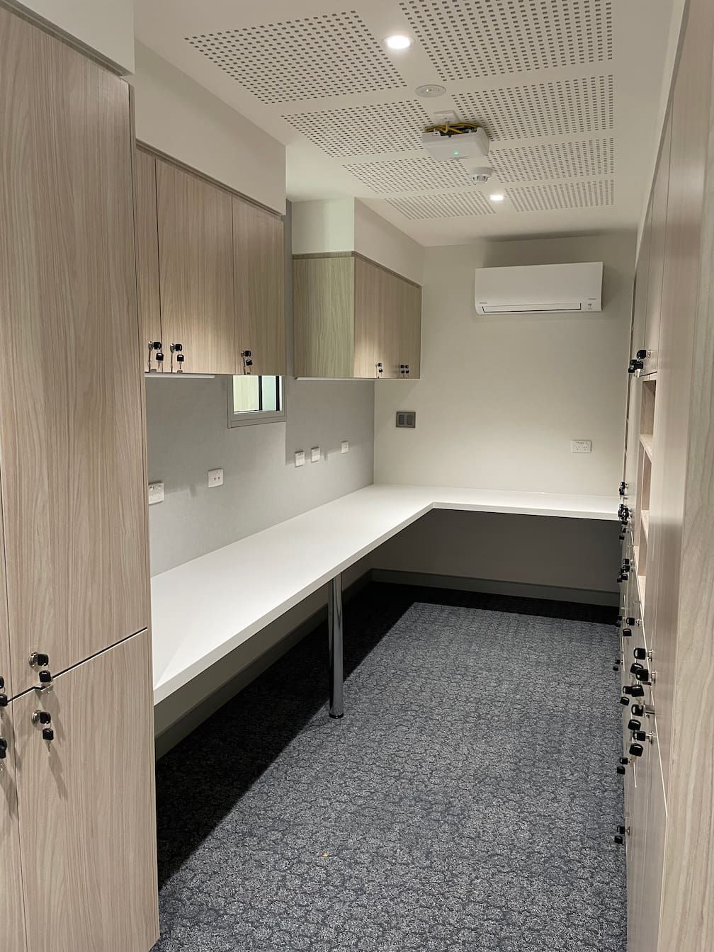 a room with a lot of lockers and a desk