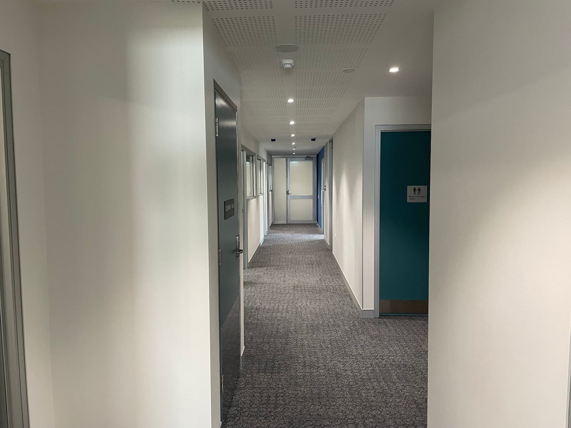 a hallway with a sign on the wall that says toilet