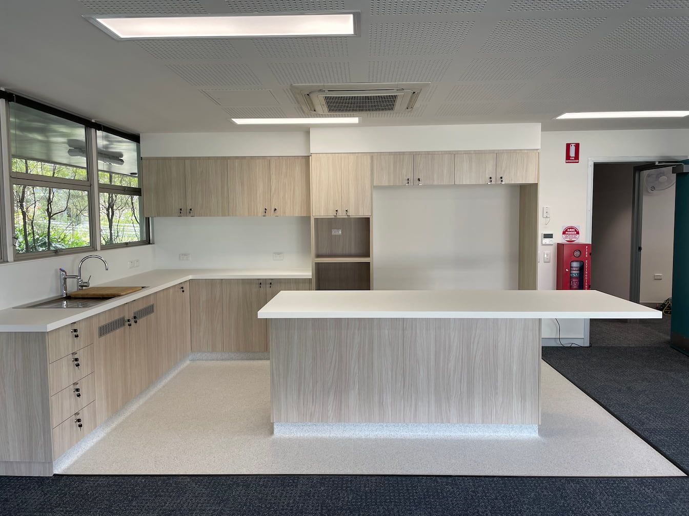 a kitchen with a fire extinguisher on the wall