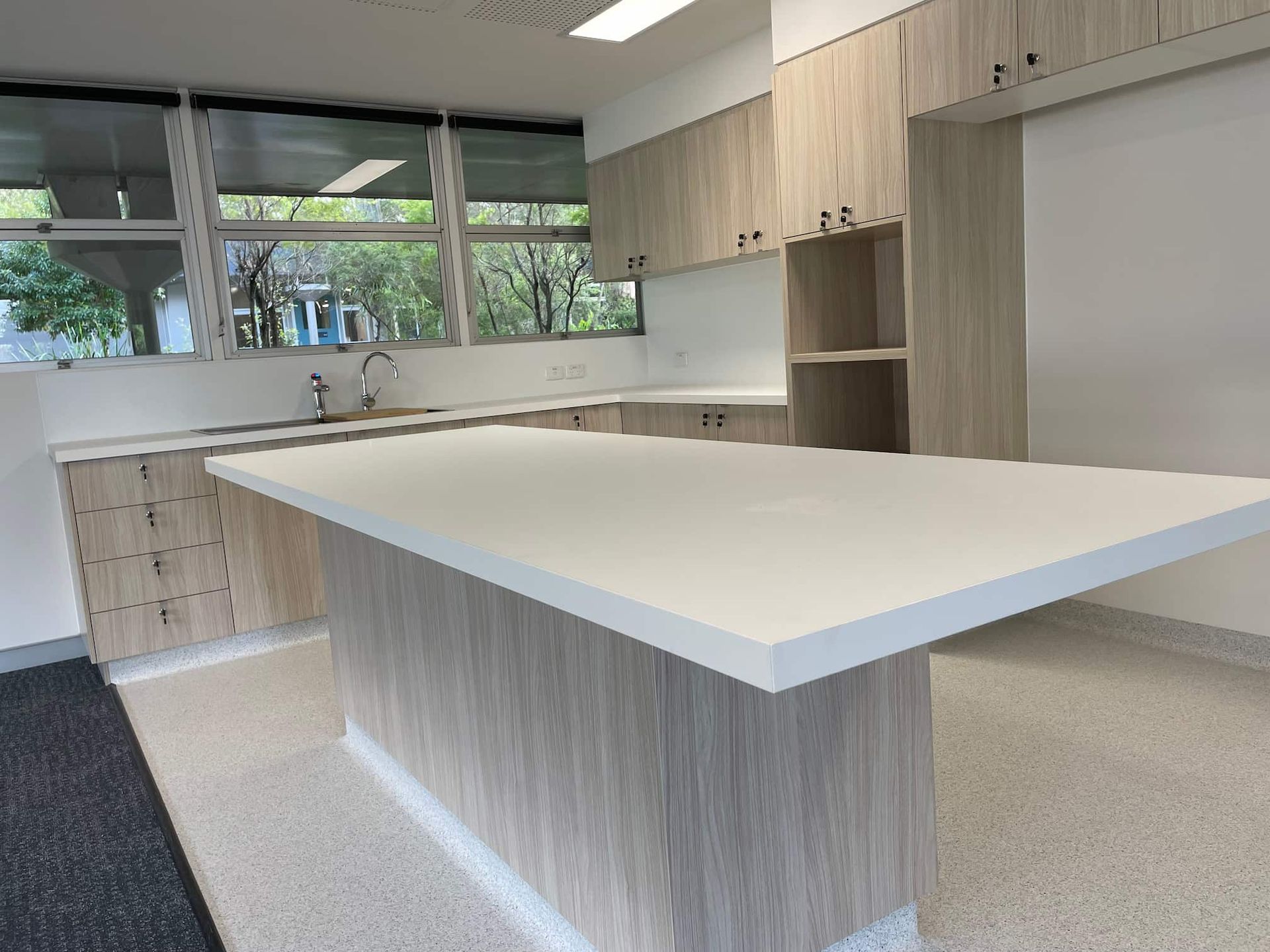 a kitchen with wooden cabinets and a white counter top