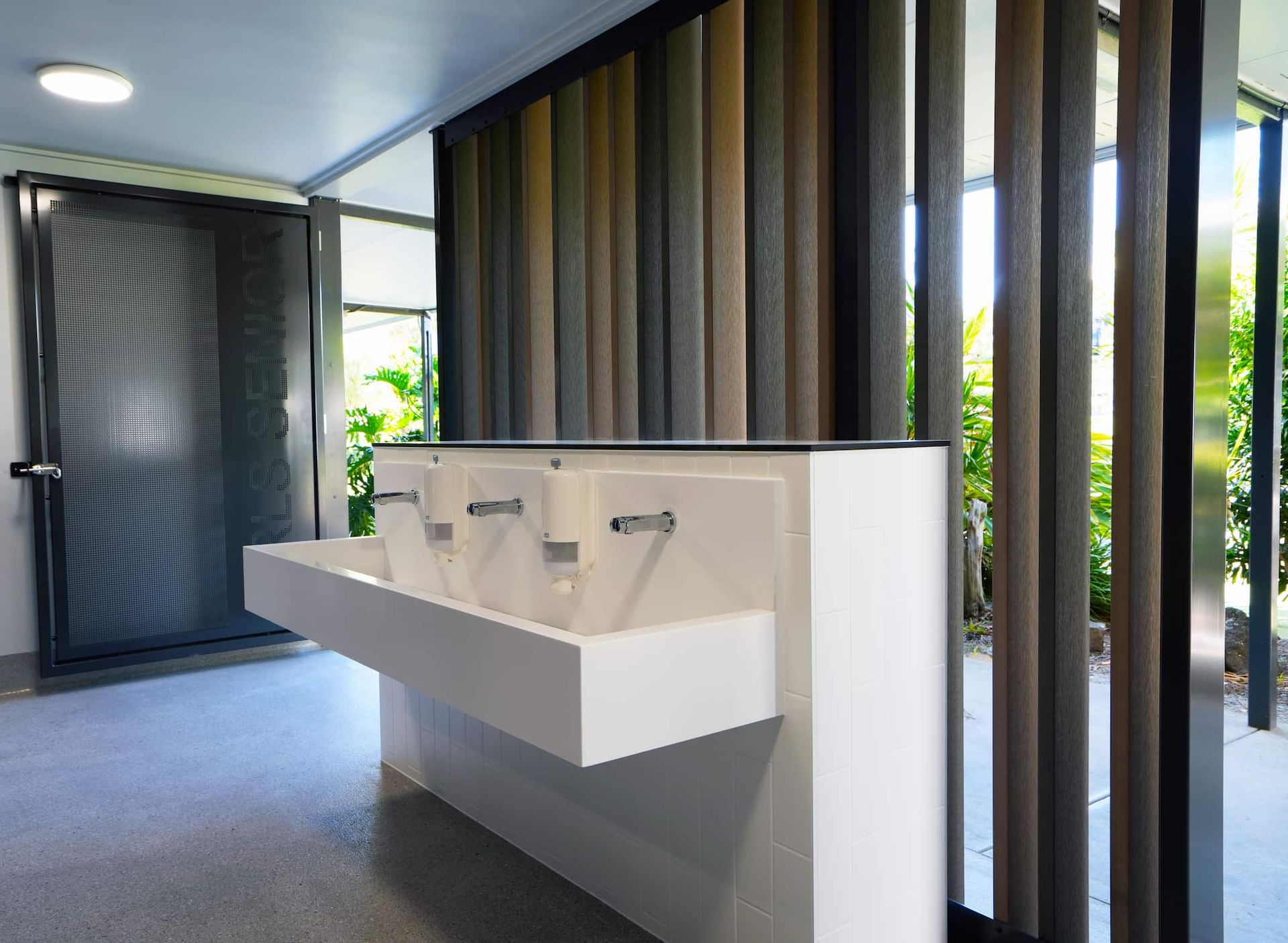 a bathroom with three sinks and a door that says ' hygiene ' on it