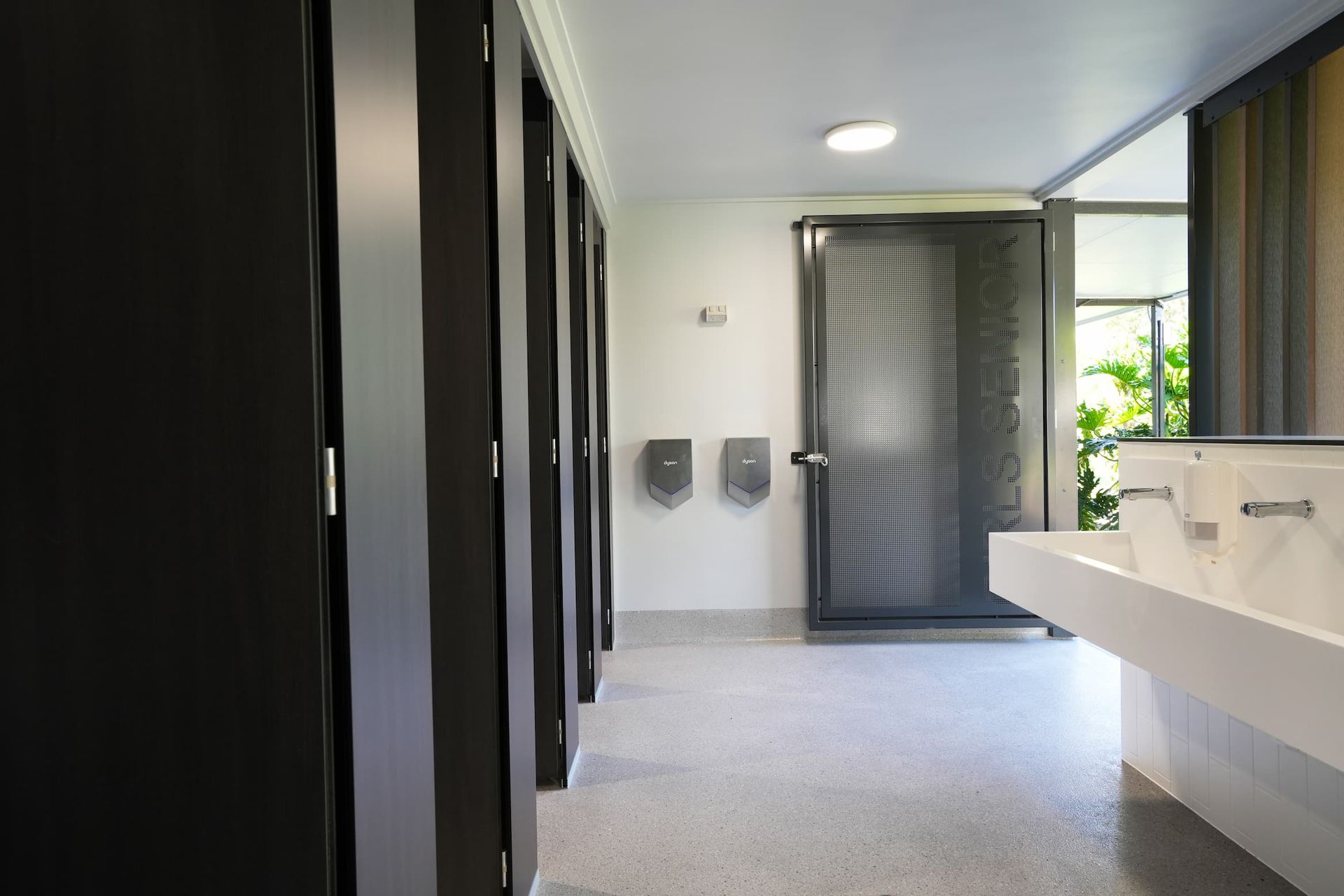 a bathroom with a door that says home on it