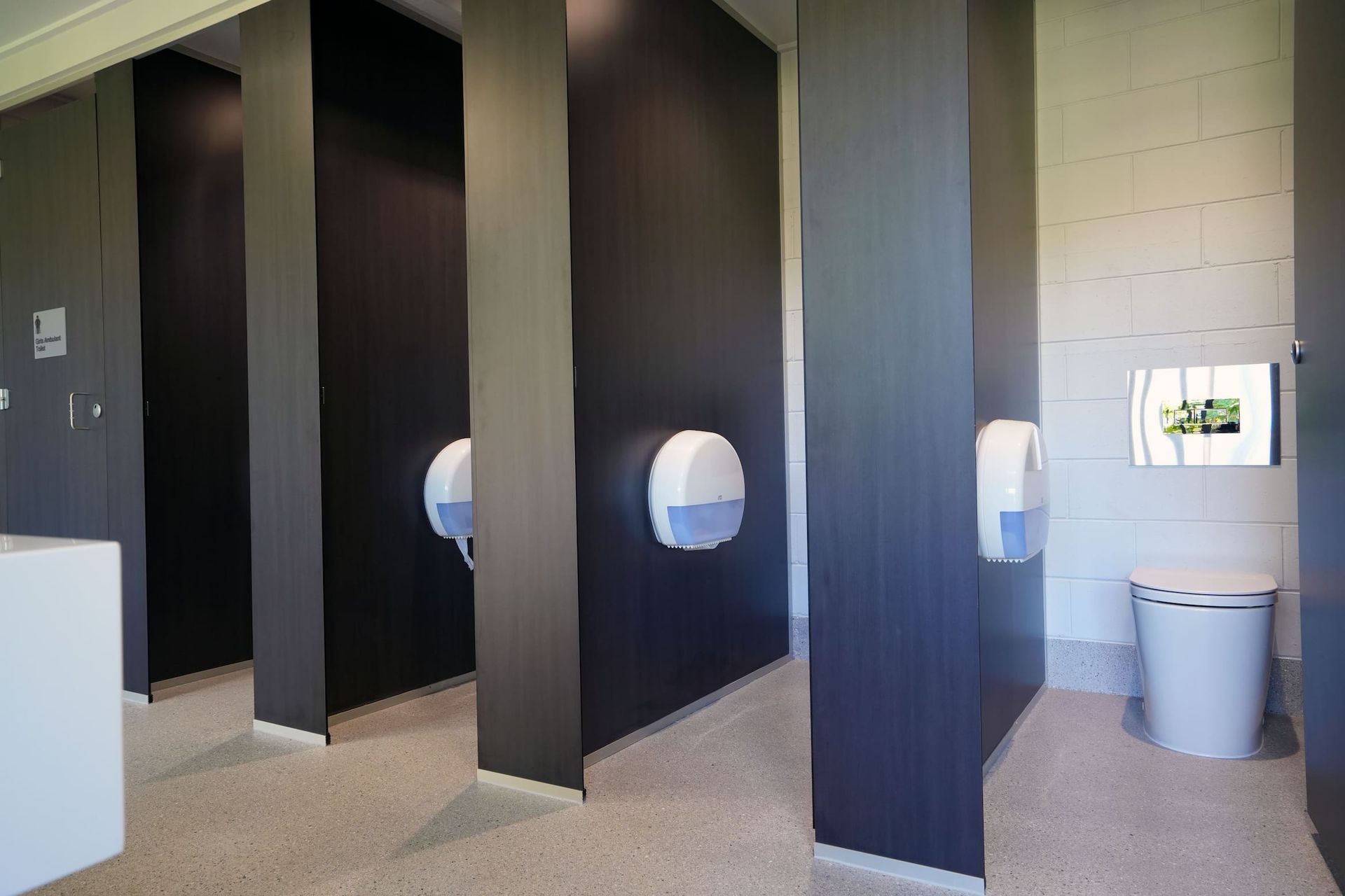 a bathroom with black walls and a white toilet
