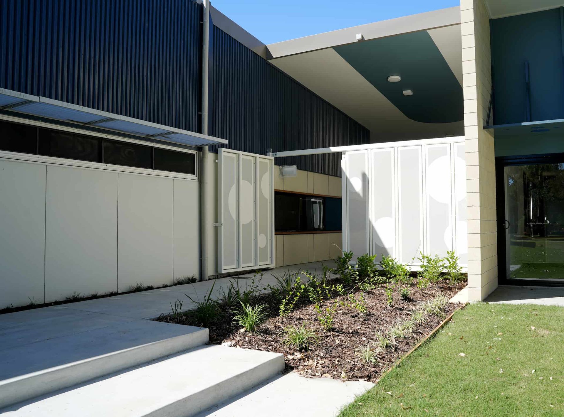 a building with a blue roof and a white door