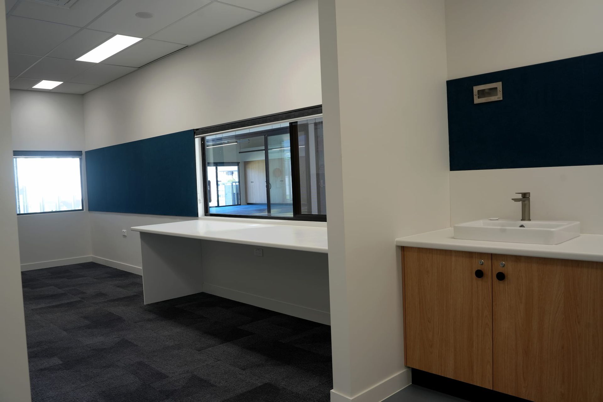 an empty room with a sink and a window