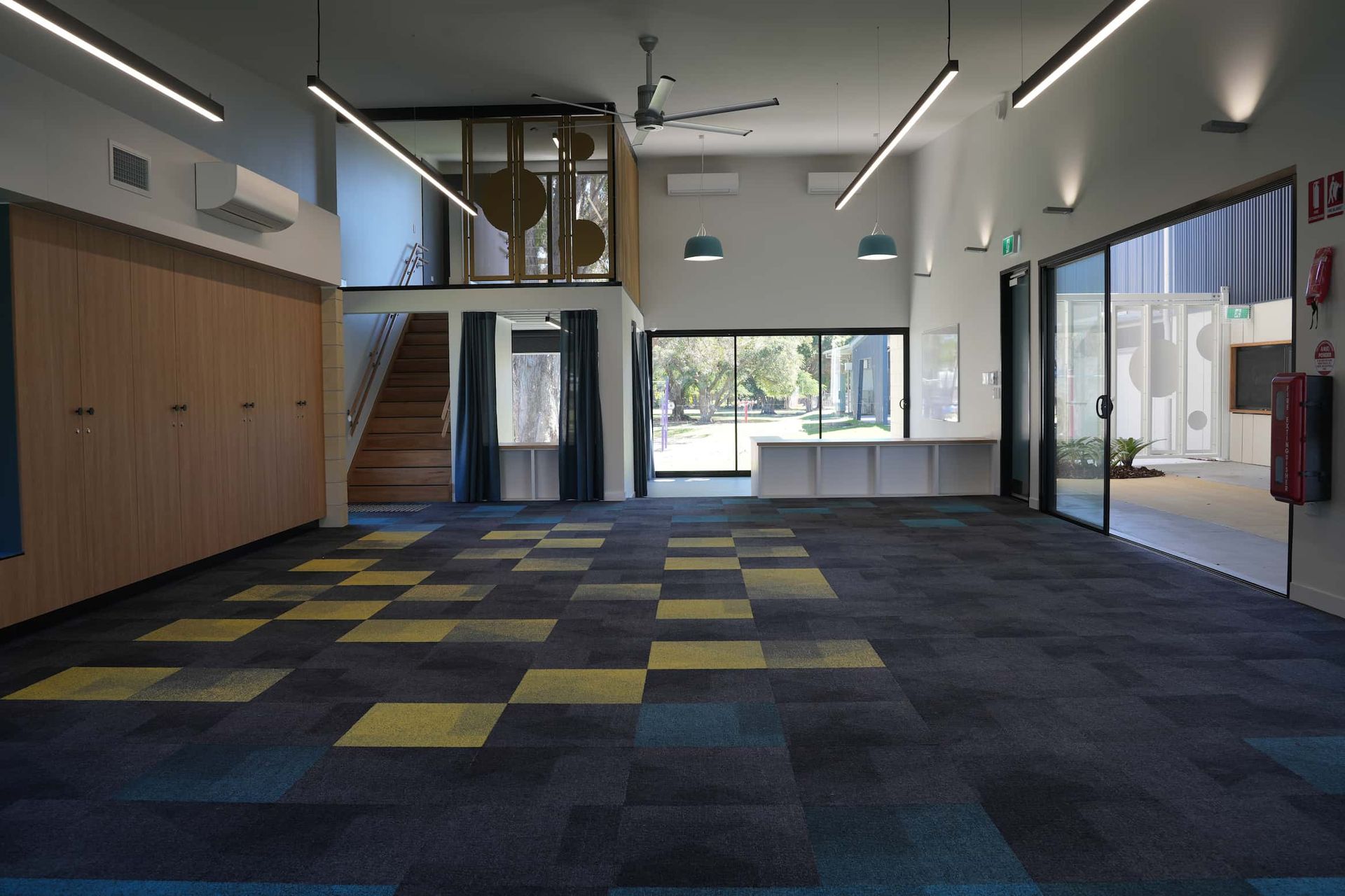 an empty room with a fire extinguisher on the wall