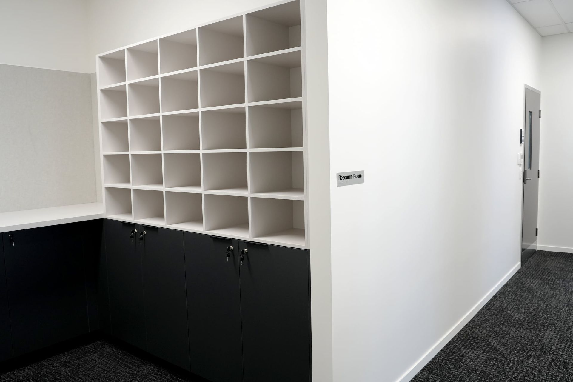 a hallway with shelves and a sign that says storage room