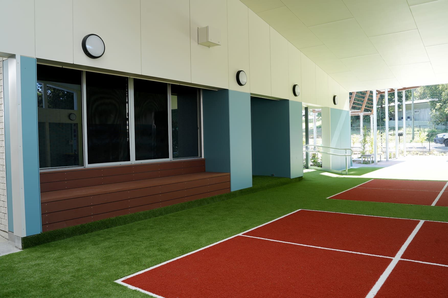 a building with a red and white track in front of it
