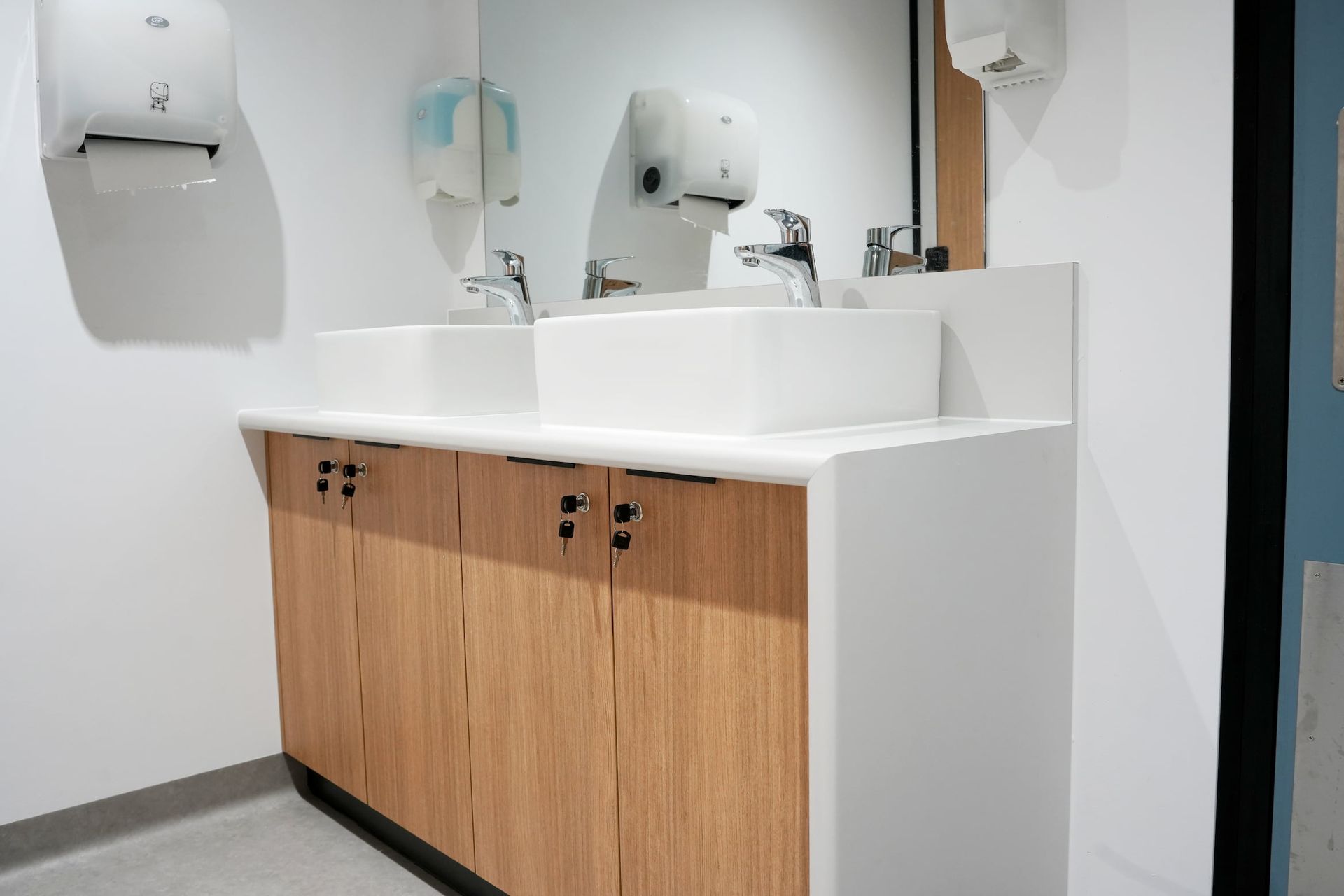 a bathroom with two sinks and a mirror at Shailer Park SHS Health Hub