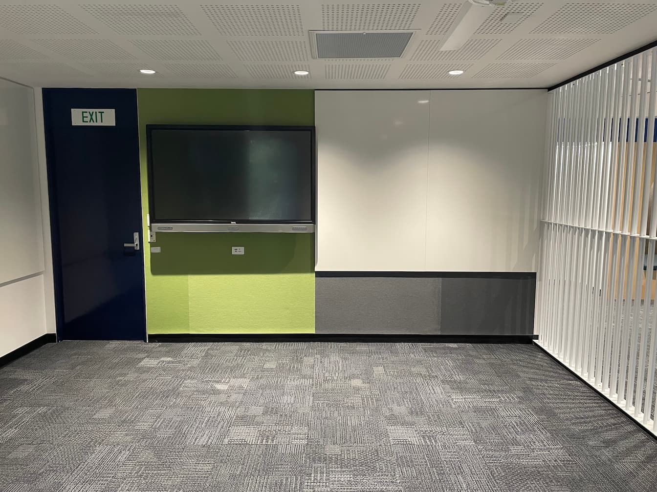 an empty room with an exit sign on the wall