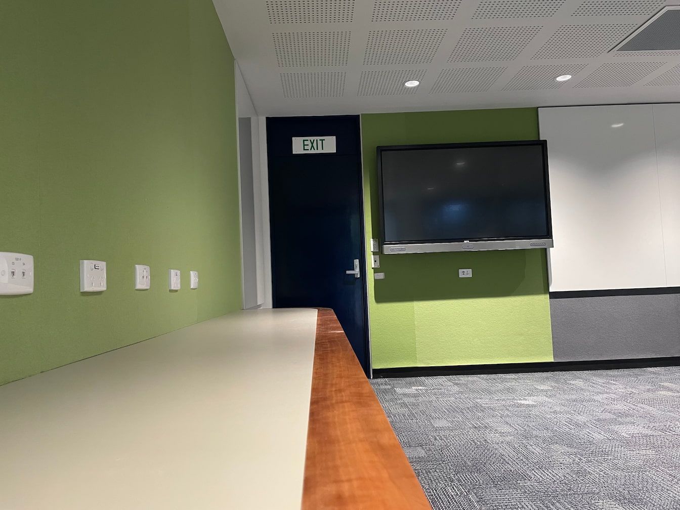 an exit sign is above a door in a room