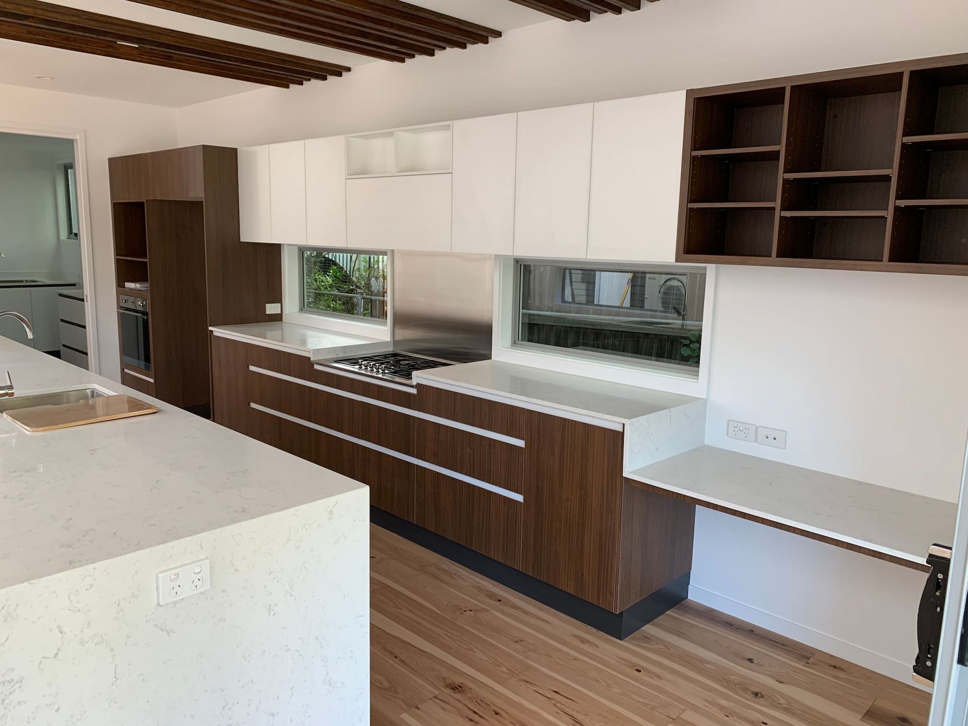 a residential kitchen with wooden cabinets and white counter tops
