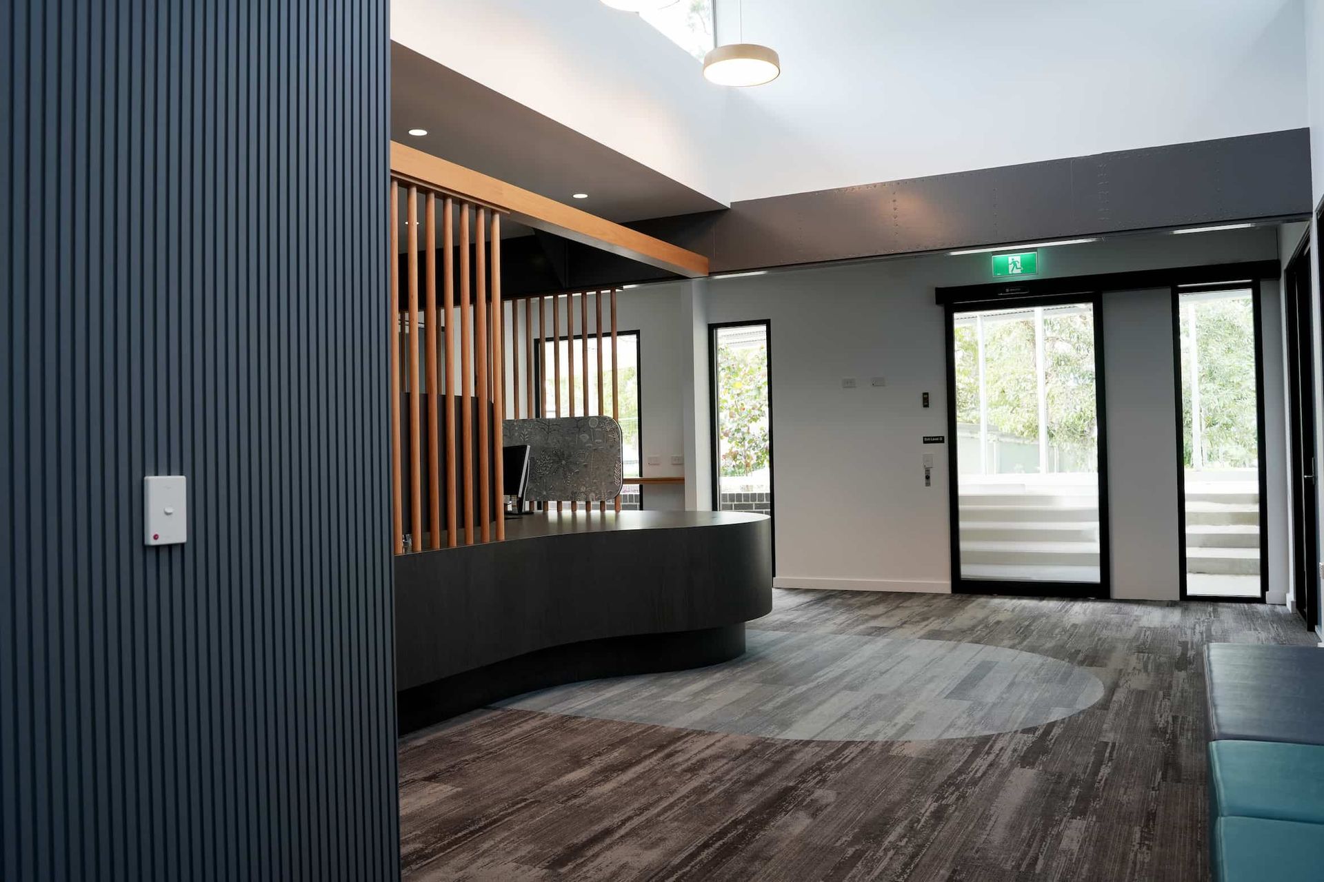 a large room with a reception desk and a sliding glass door at Shailer Park SHS Health Hub