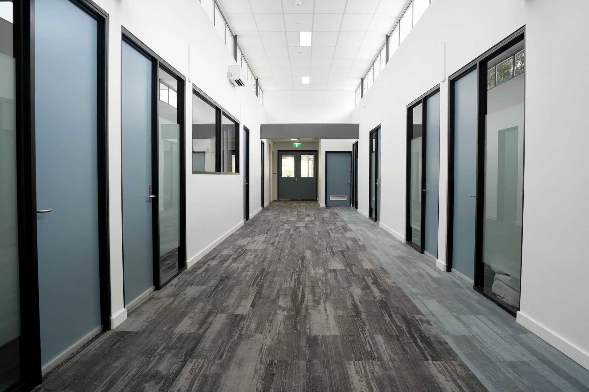 a long hallway with a lot of doors and windows at Shailer Park SHS Health Hub