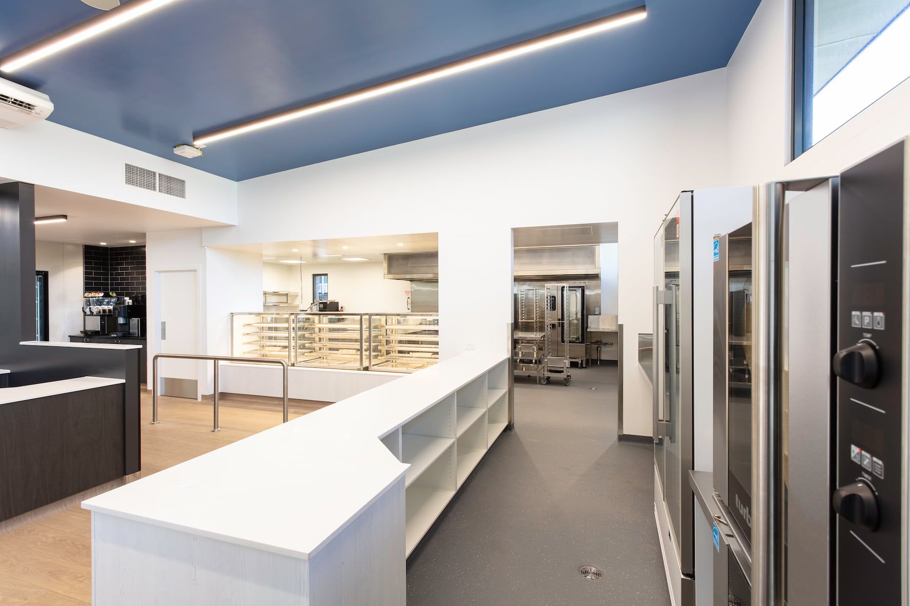 a kitchen with a blue ceiling and white walls