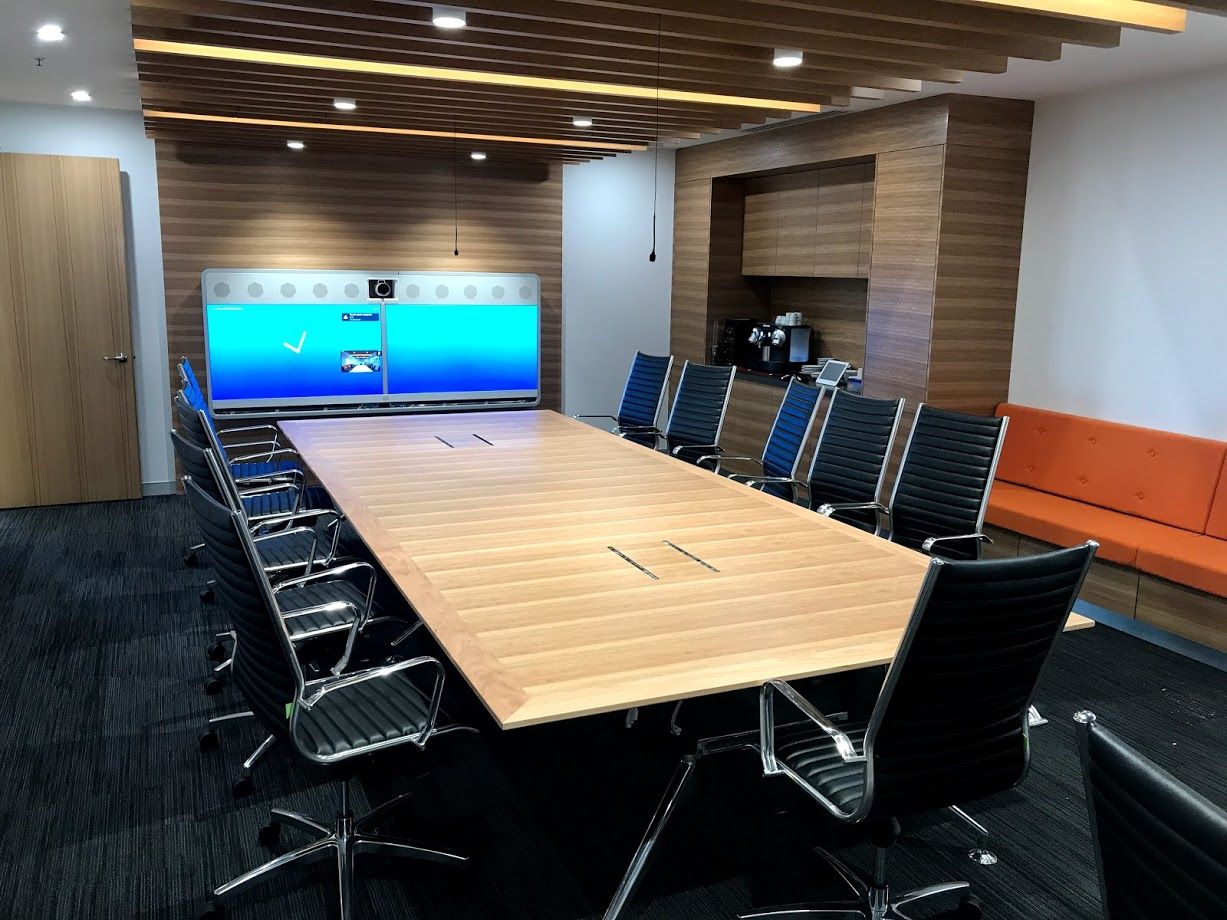 a conference room with a long wooden table and chairs