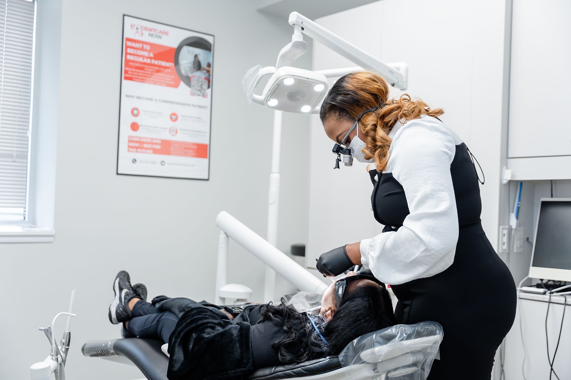 Dentist treating a patient in dental clinic with overhead exam light at DentCare Now, emergency dentist serving Fairfax, VA