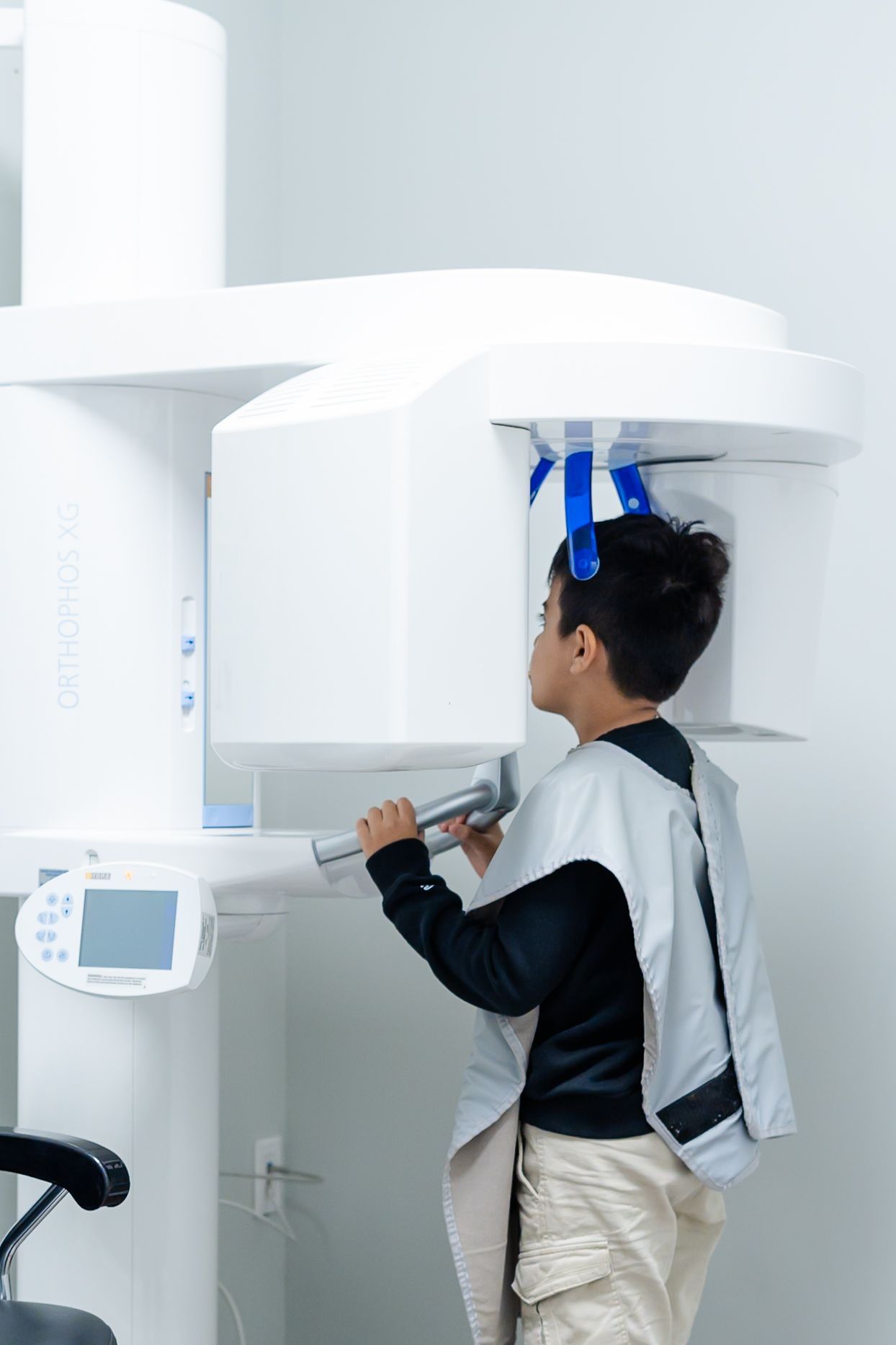 Person undergoing a dental scan in a white medical imaging room at DentCare Now, emergency dentist serving Fairfax, VA
