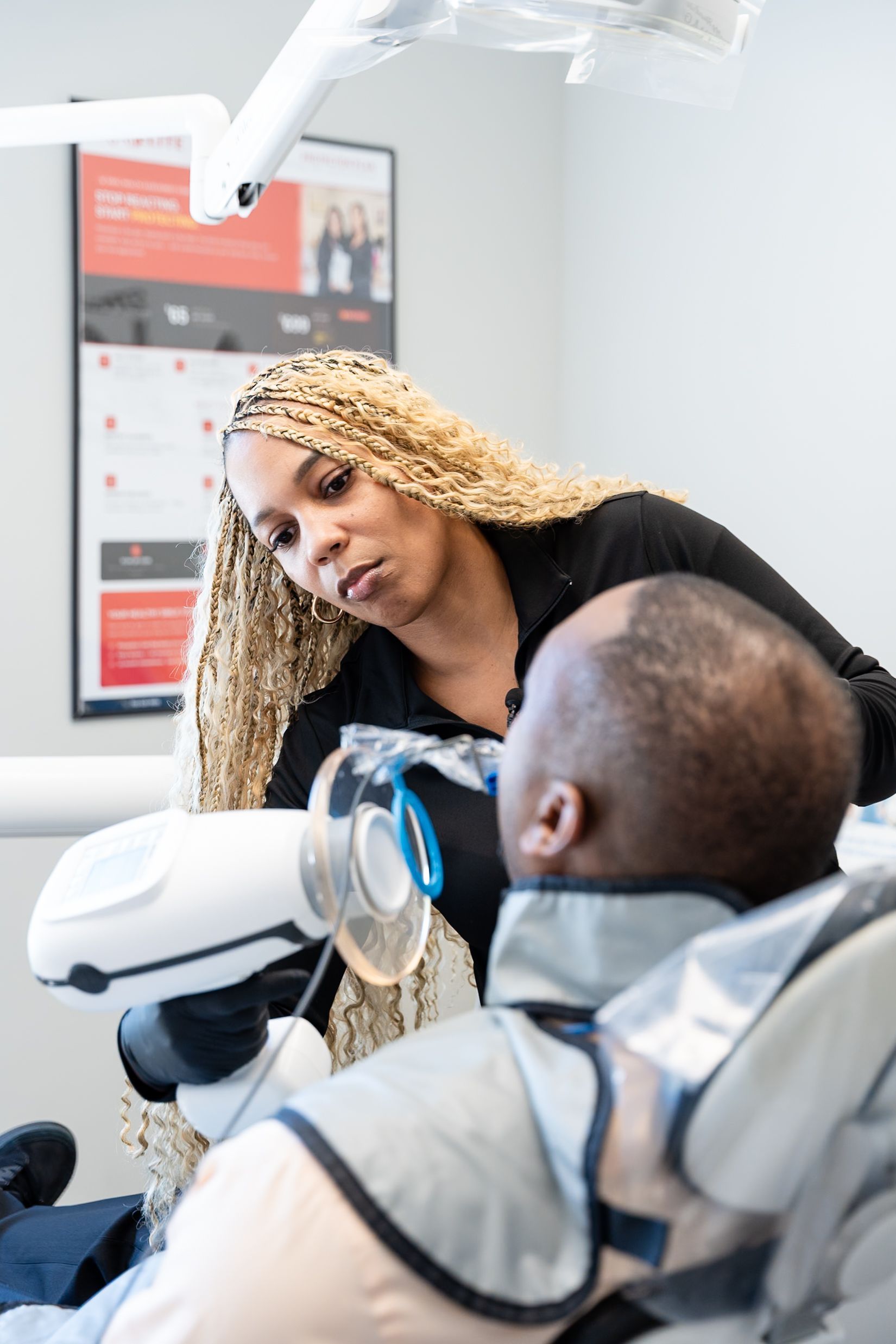 Dentist talking to seated patient in a dental clinic at DentCare Now, emergency dentist serving Fairfax, VA