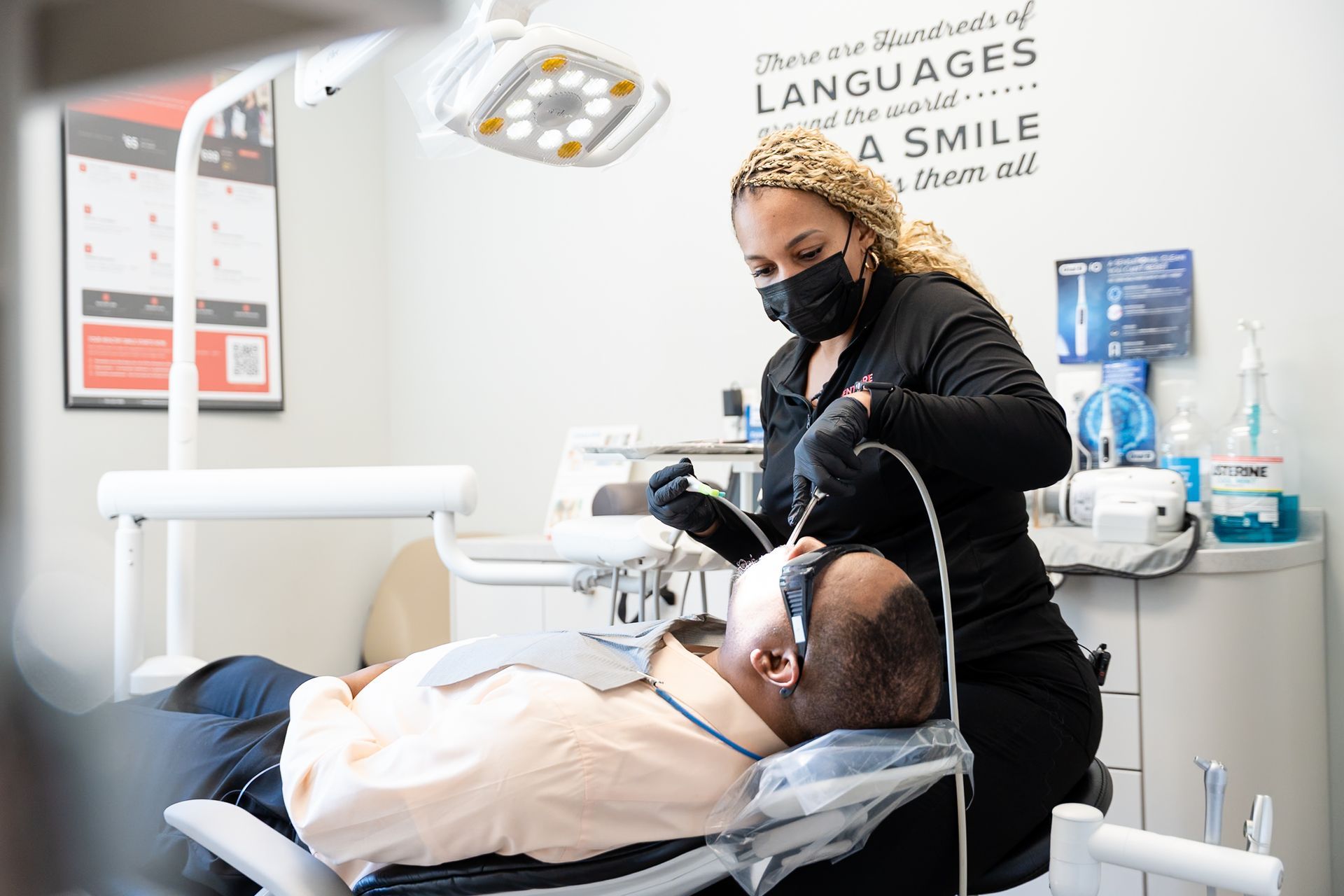 Dentist examining a reclining patient in a bright dental clinic at DentCare Now, emergency dentist serving Fairfax, VA