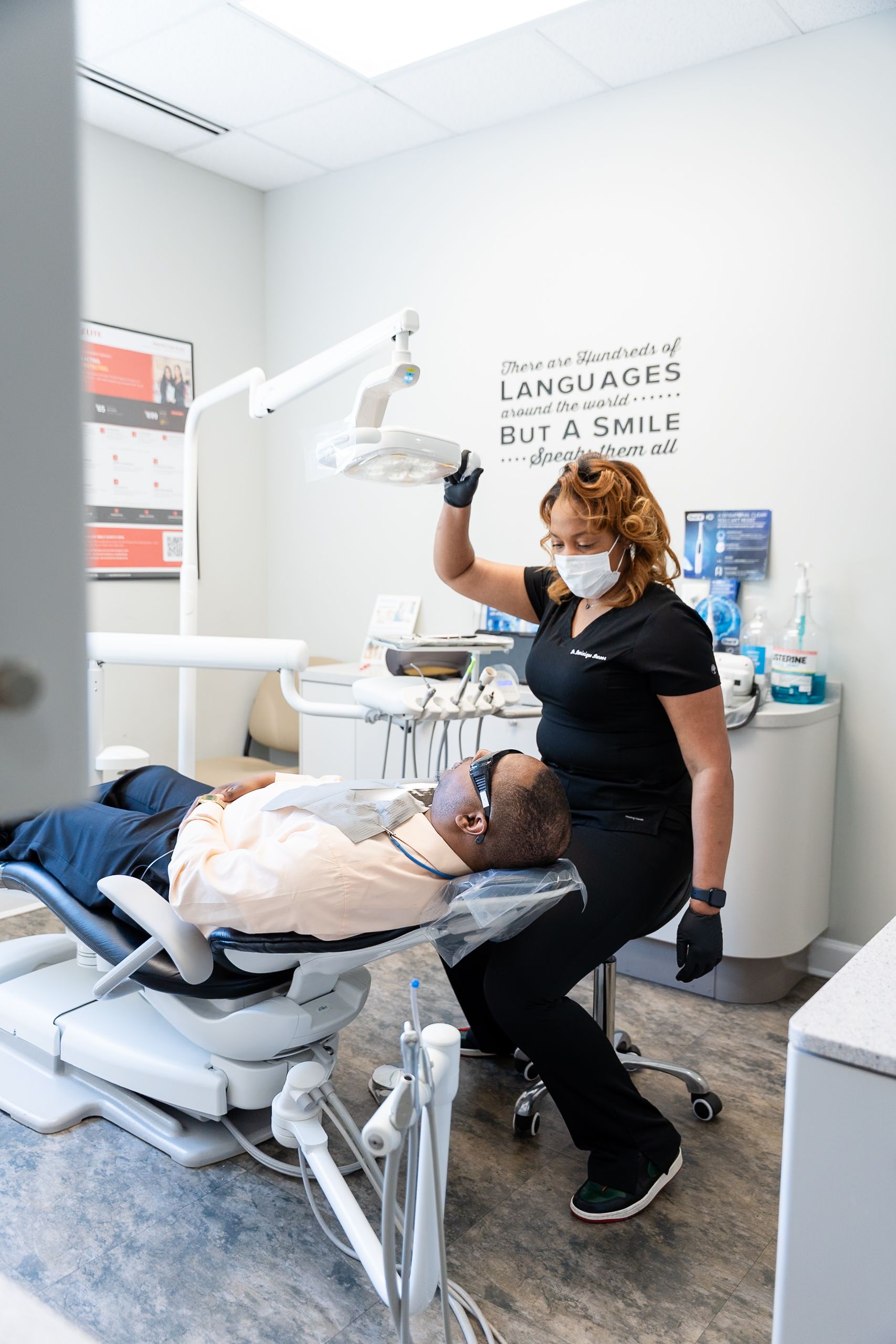 Dentist treating reclining patient in a dental exam room at DentCare Now, emergency dentist serving Fairfax, VA
