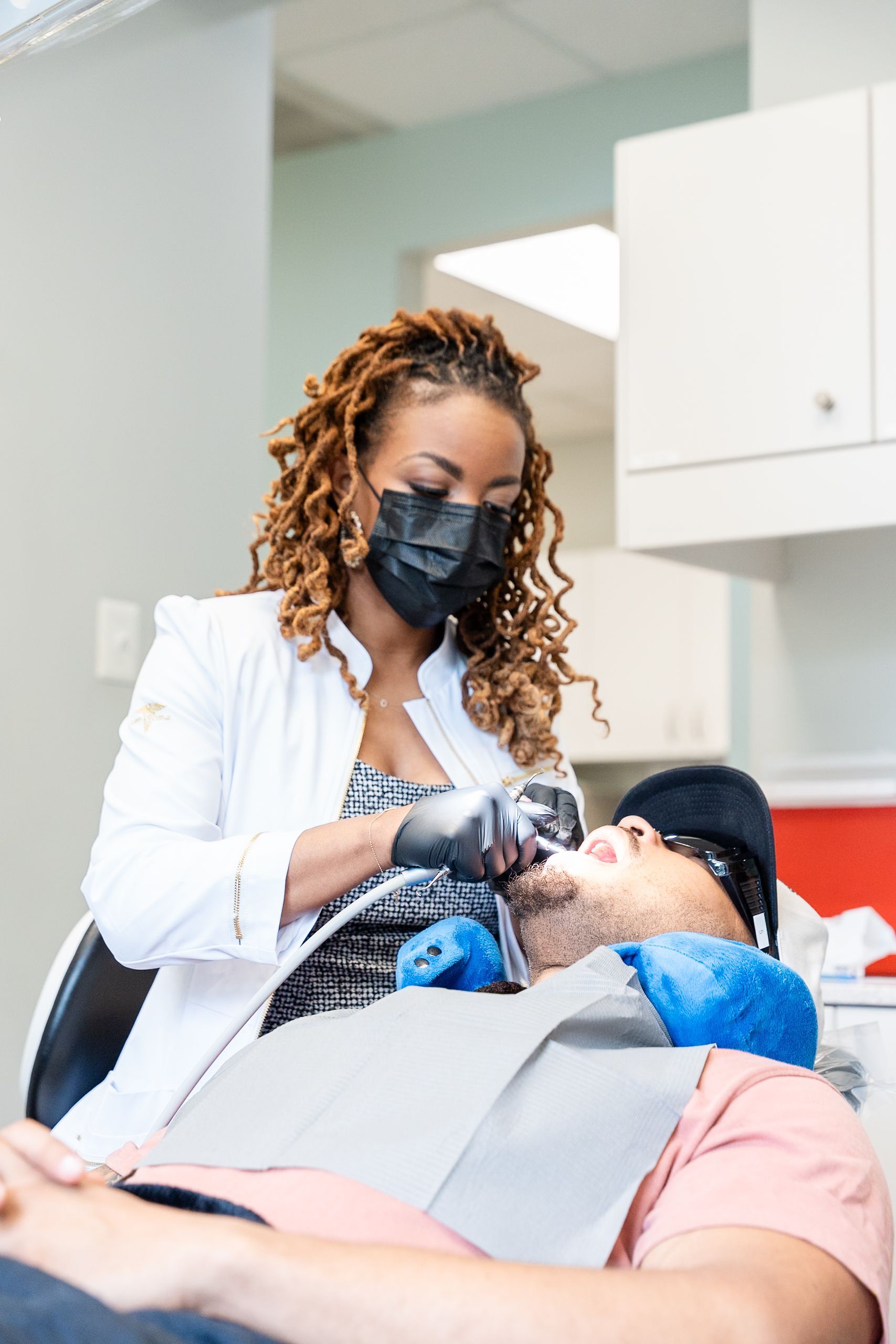 Dentist examining a patient’s mouth in a clinic, wearing gloves at DentCare Now, emergency dentist serving Fairfax, VA