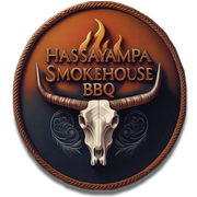 Hassayampa Smokehouse BBQ logo with a longhorn skull, rope border, and flames on a brown circular badge