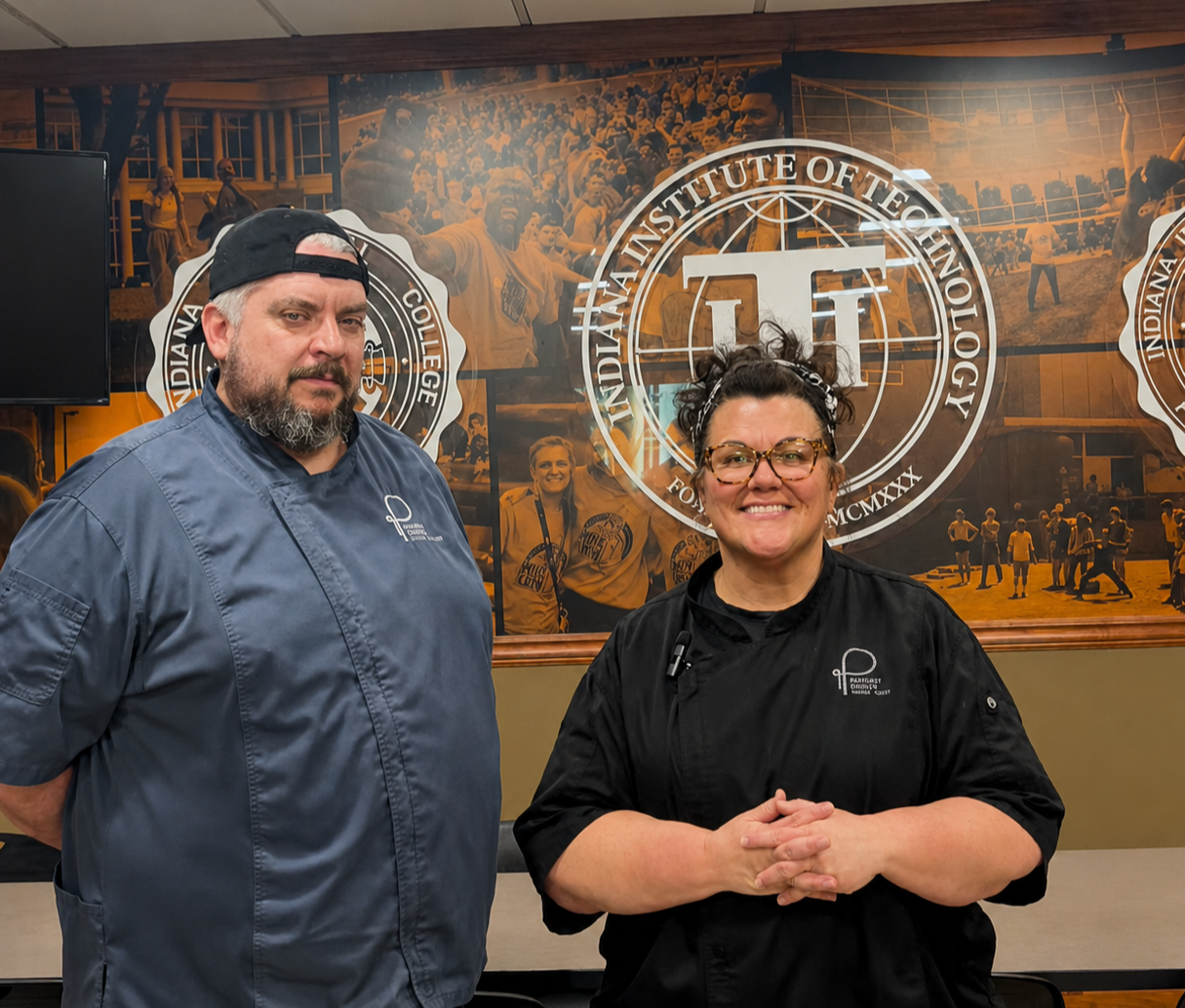 A man in a chef 's hat is posing for a picture with two other chefs