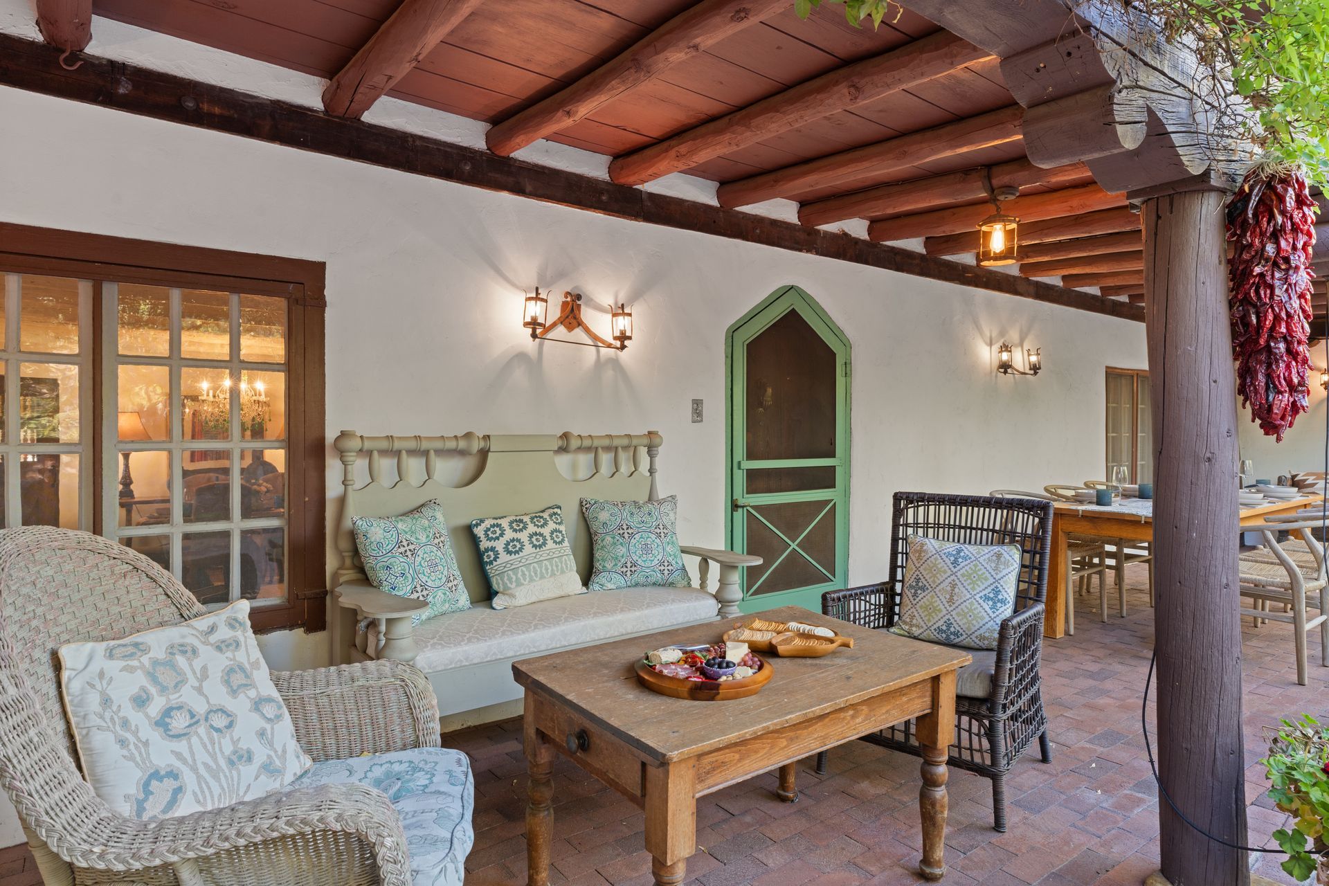 The Boyle House portal, with its green doorway, timber beams, and courtyard seating