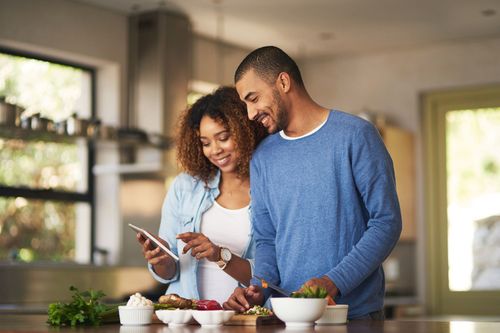 Couple preparing their healthy food in kitchen