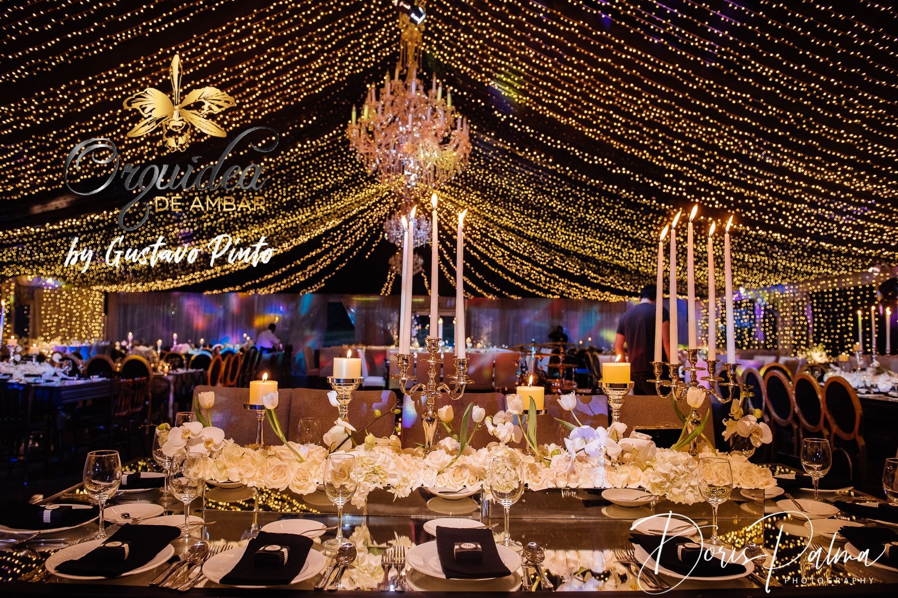 A table with a chandelier and candles on it