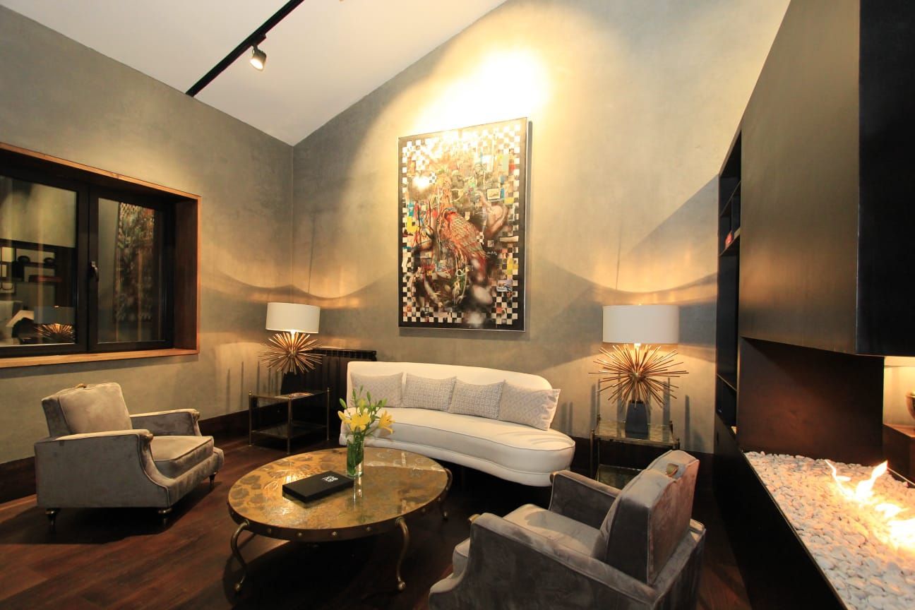 A living room with a couch , chairs and a coffee table