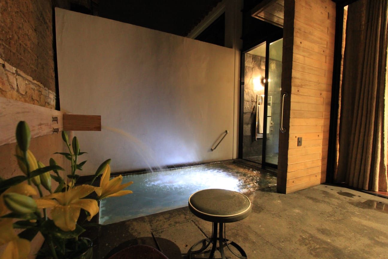 Una habitación con una piscina y un taburete dentro.