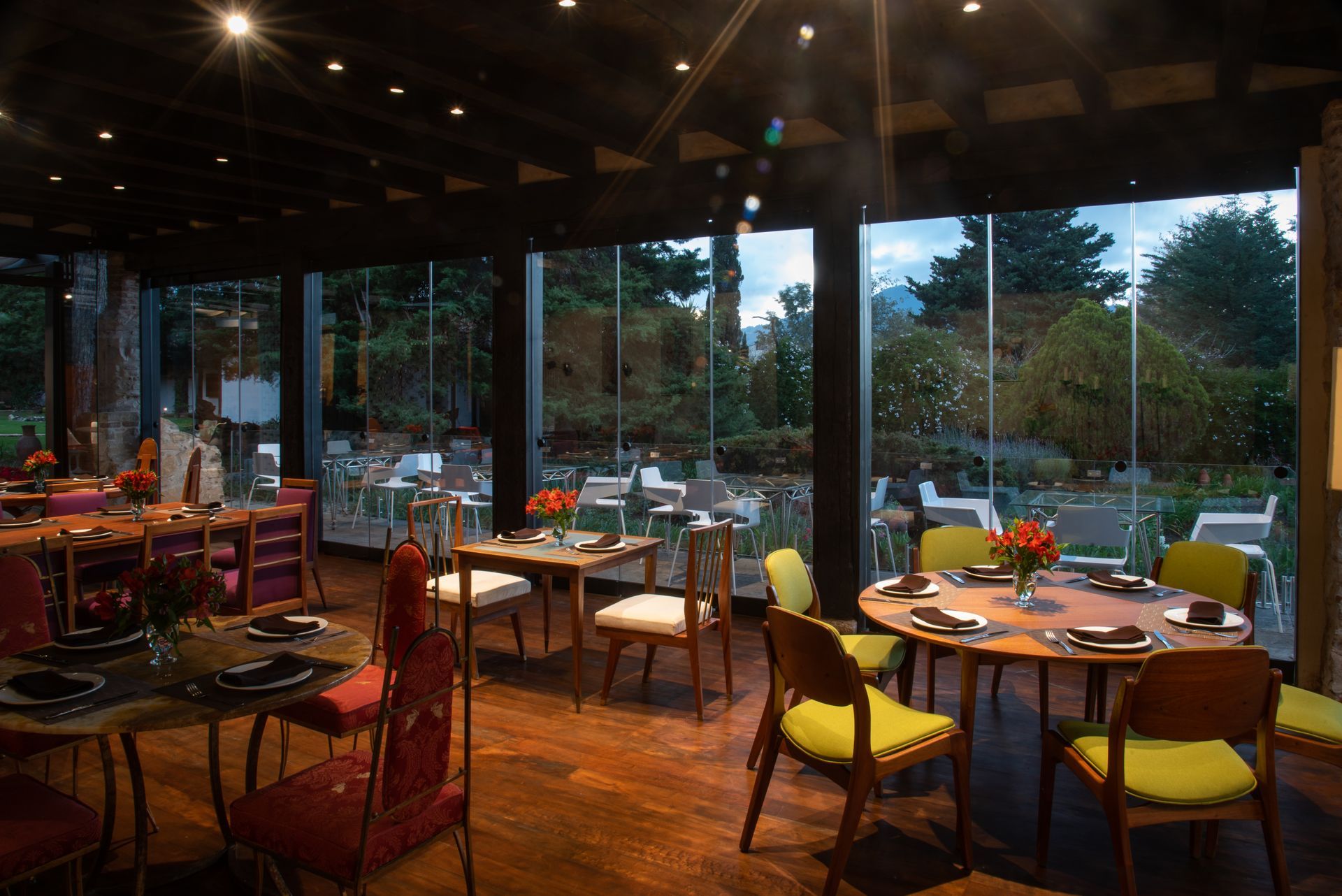 Un restaurante con mesas y sillas y muchas ventanas.